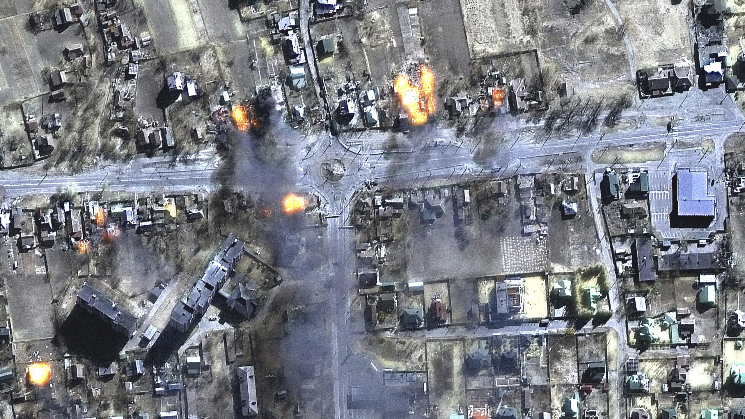 This satellite image provided by Maxar Technologies shows burning buildings in a residential area i...