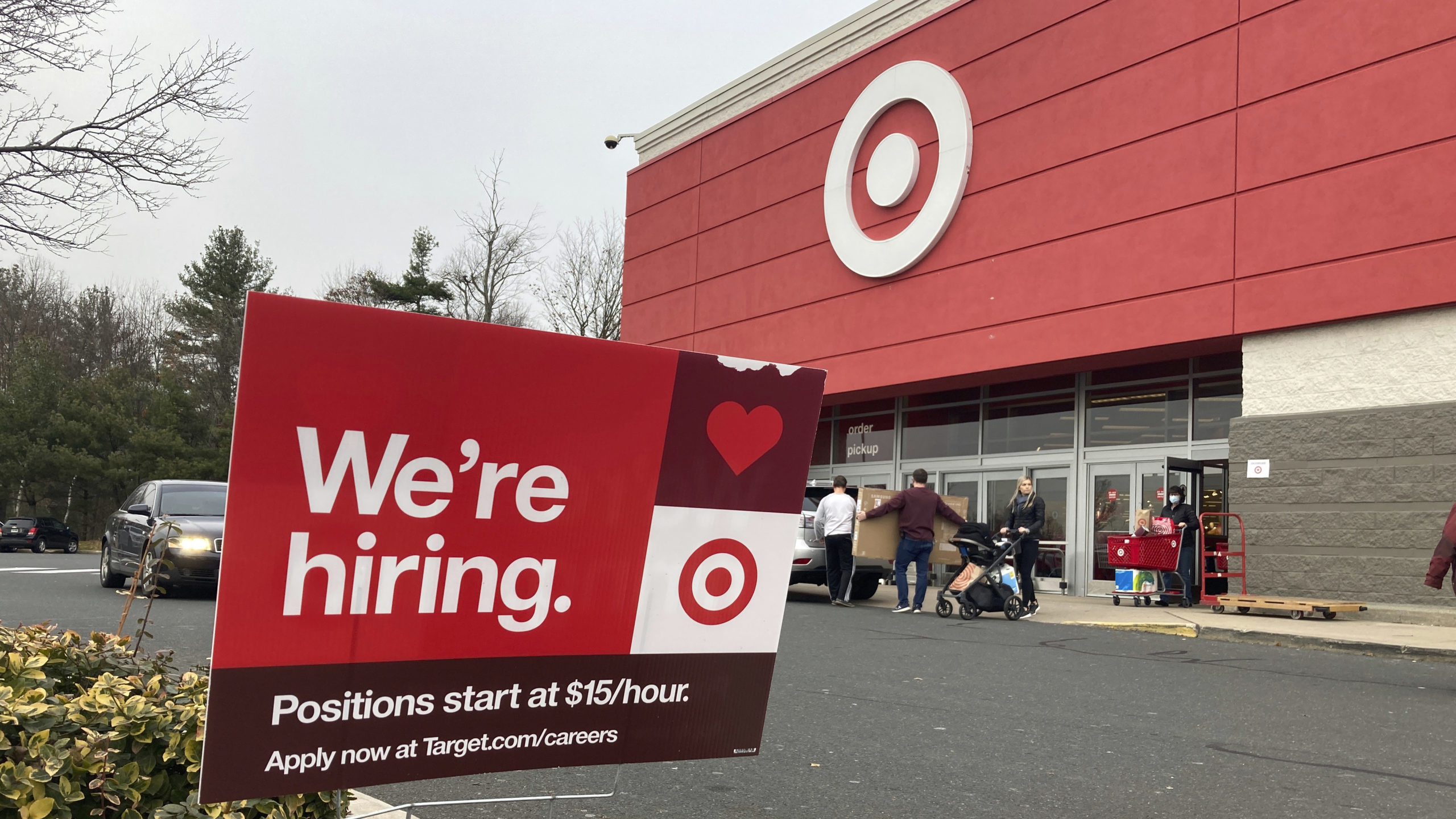 FILE - A hiring sign is in front of a Target store in Manchester, Conn., Nov. 39, 2021. (AP Photo/T...