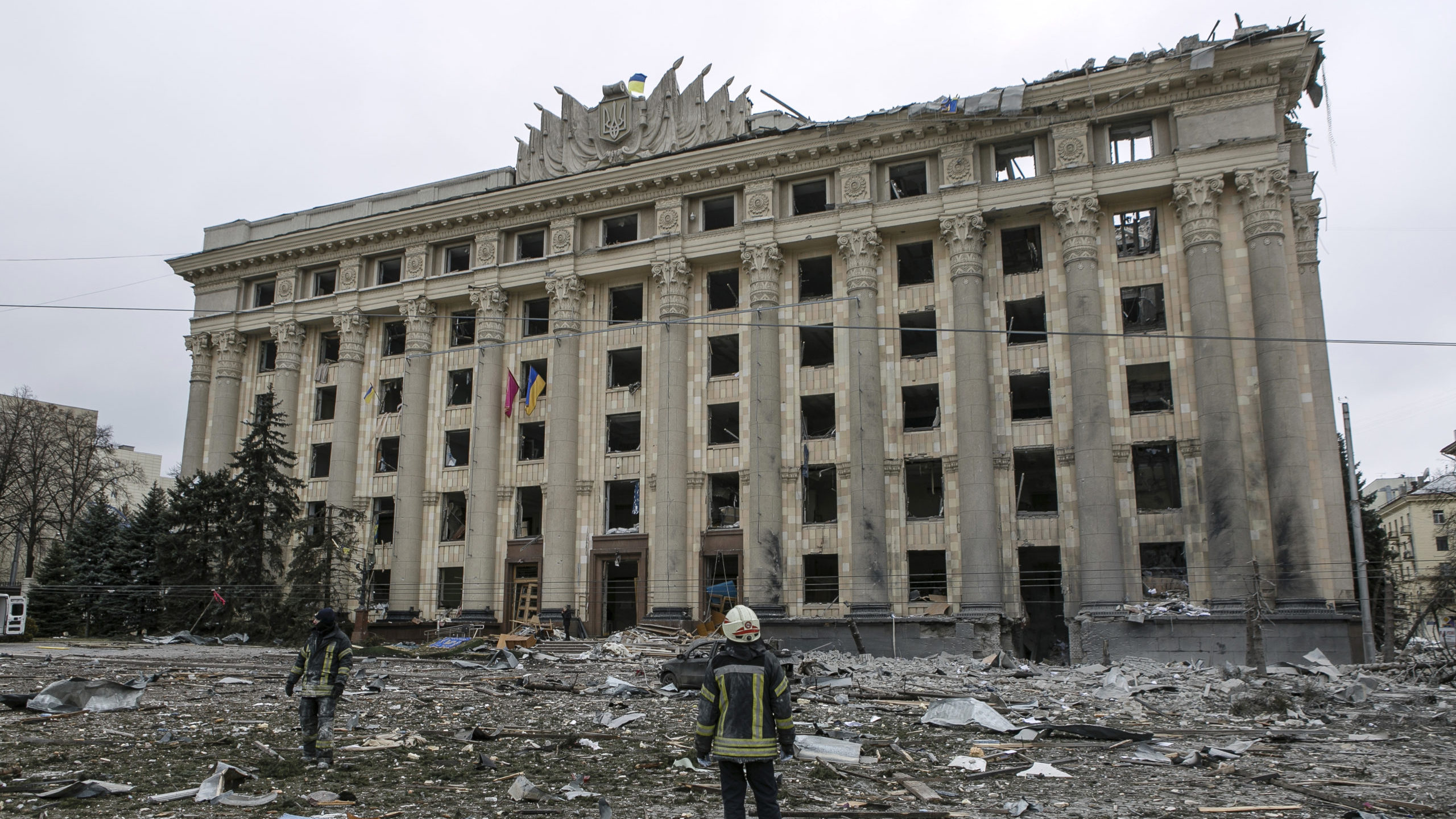 A member of the Ukrainian Emergency Service looks at the City Hall building in the central square f...