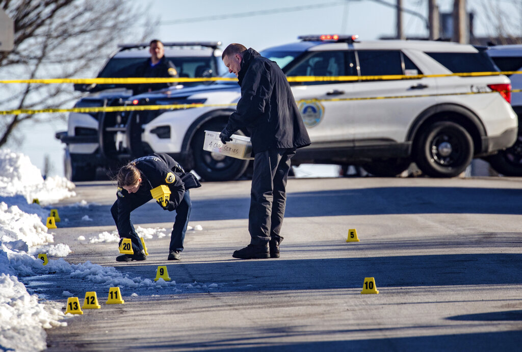 Police investigate a shooting outside of East High School in in Des Moines, Iowa, on Monday, March ...