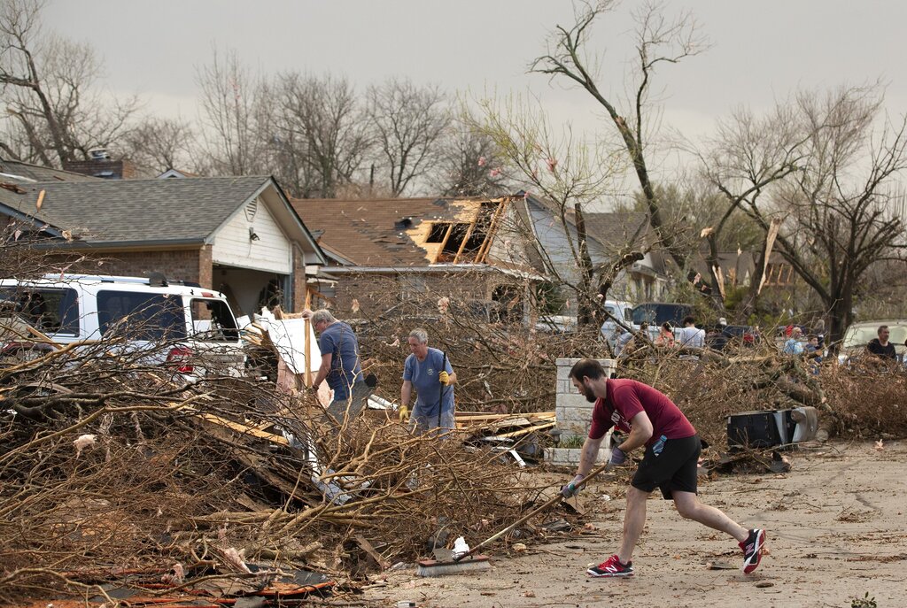 Jarrod Schneider, who lives on Oxford Drive in Round Rock, Texas, helps his neighbors clean up afte...