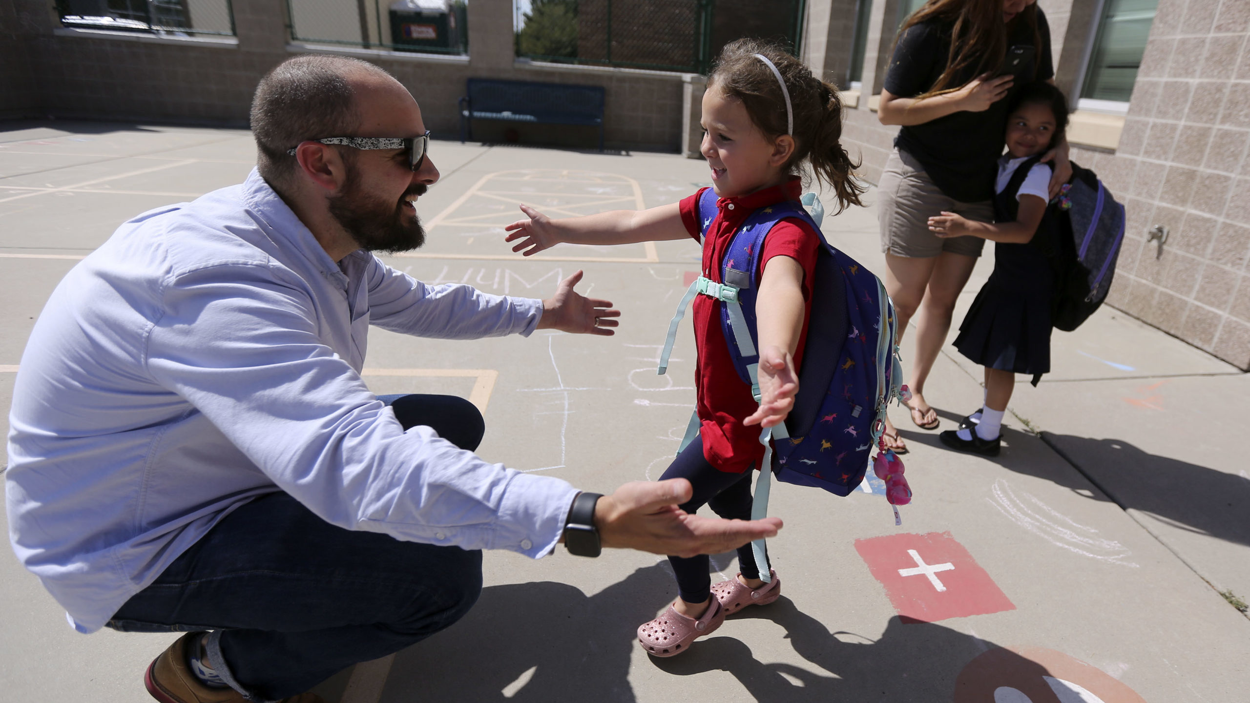Chris Conard picks up his daughter Hazel Conard from kindergarten at Whittier Elementary School in ...