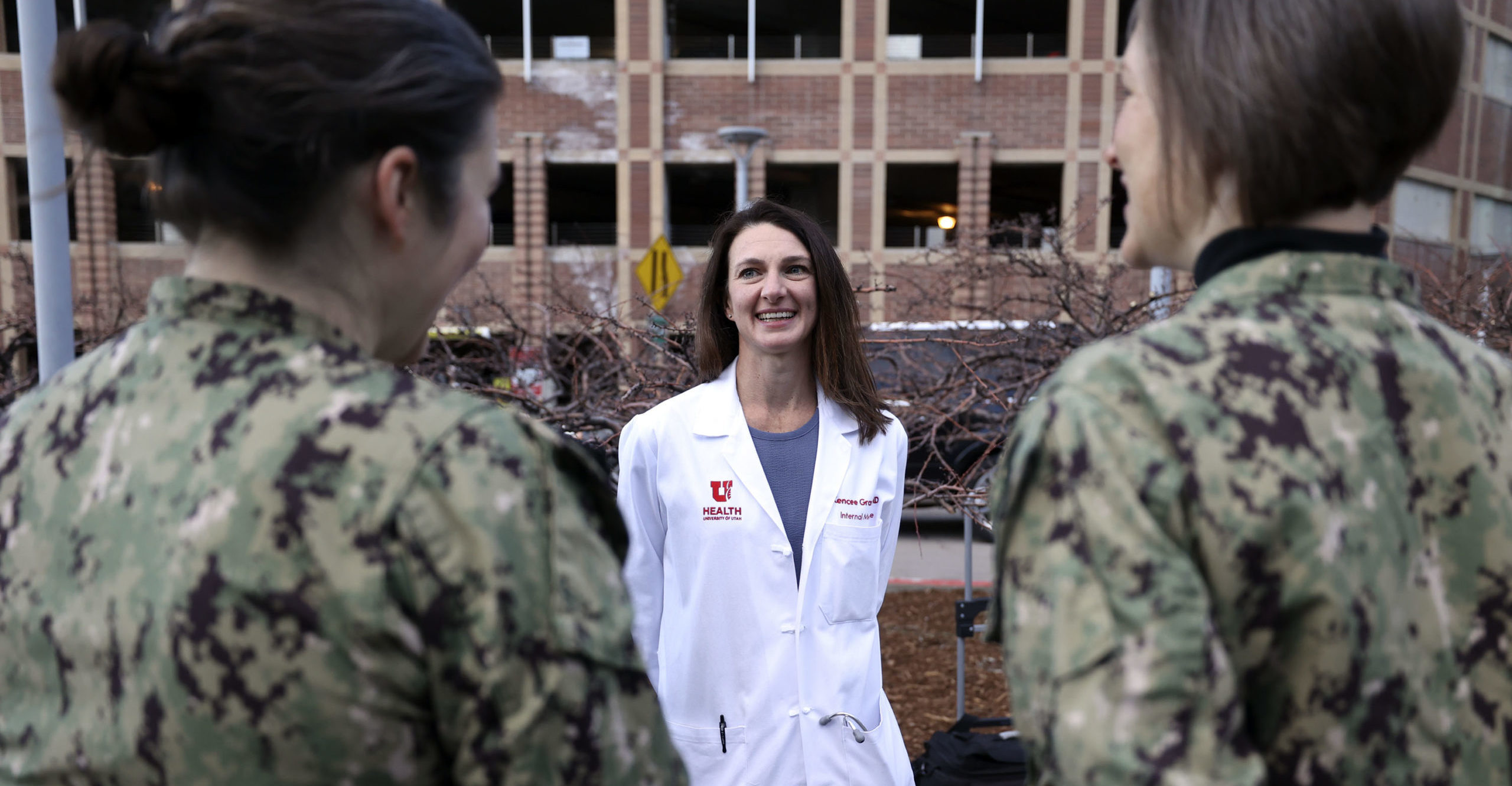 Dr. Kencee Graves talks with members of the U.S. Navy as they arrive to support the University of U...