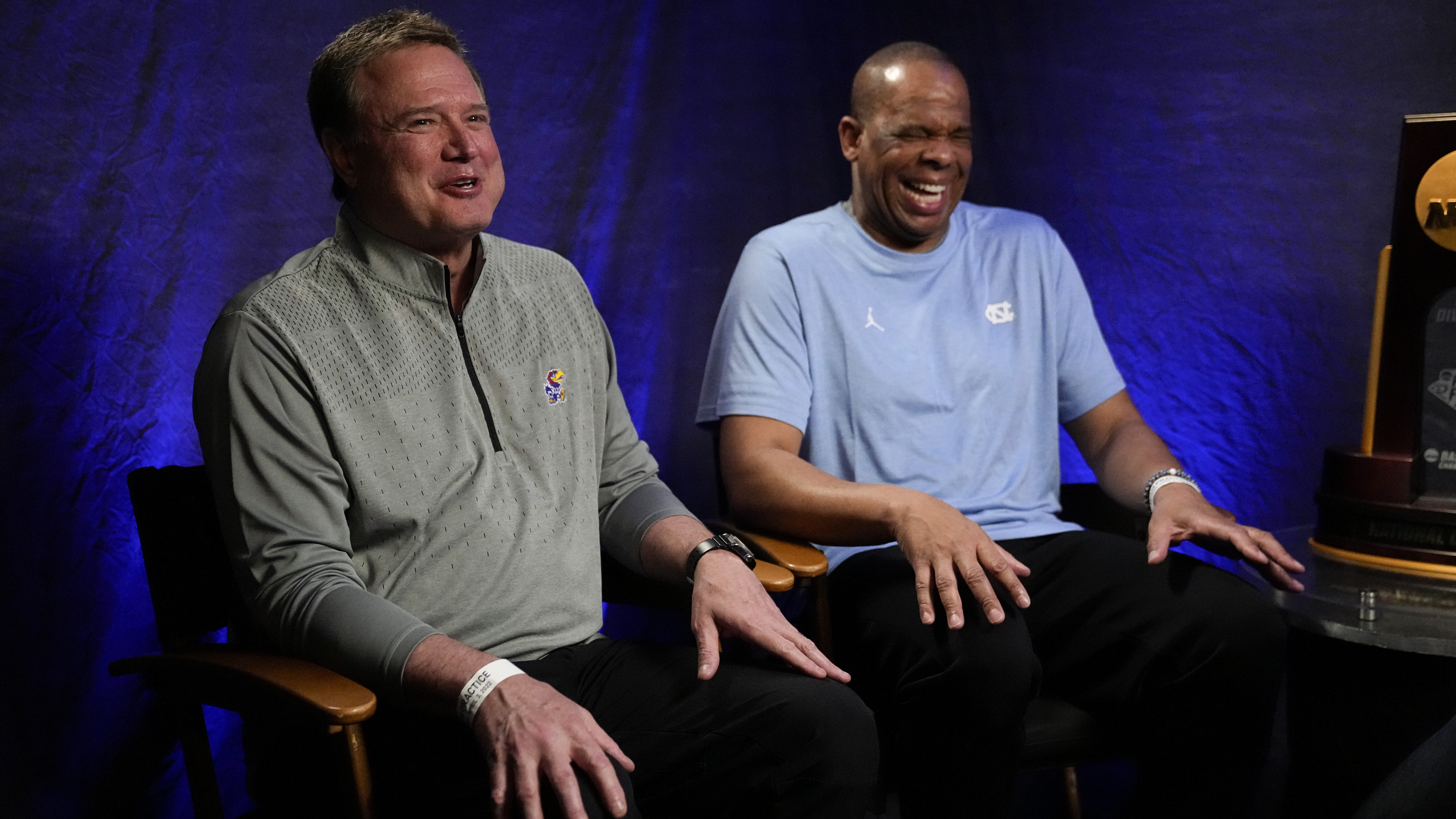 Kansas head coach Bill Self, left, and North Carolina head coach Hubert Davis talk during a CBS Spo...