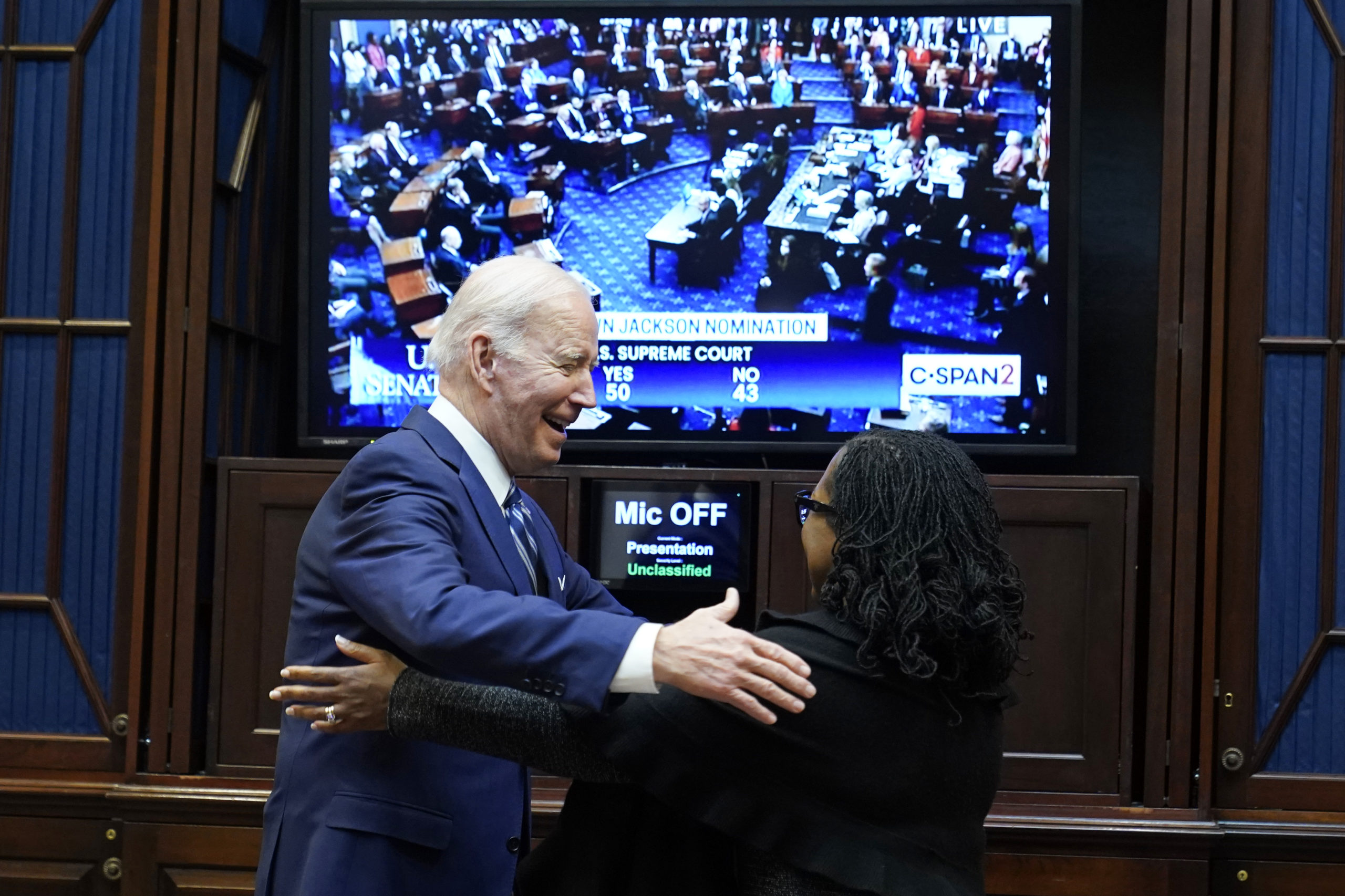 President Joe Biden goes to hug Supreme Court nominee Judge Ketanji Brown Jackson as they watch the...