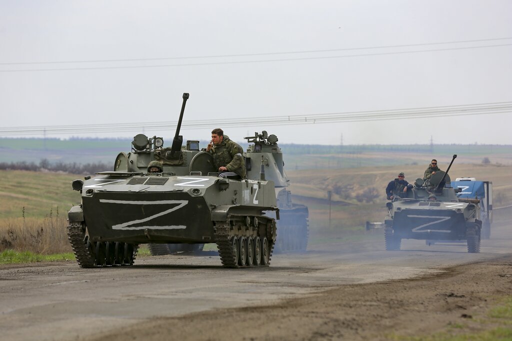 Russian military vehicles move on a highway in an area controlled by Russian-backed separatist forc...