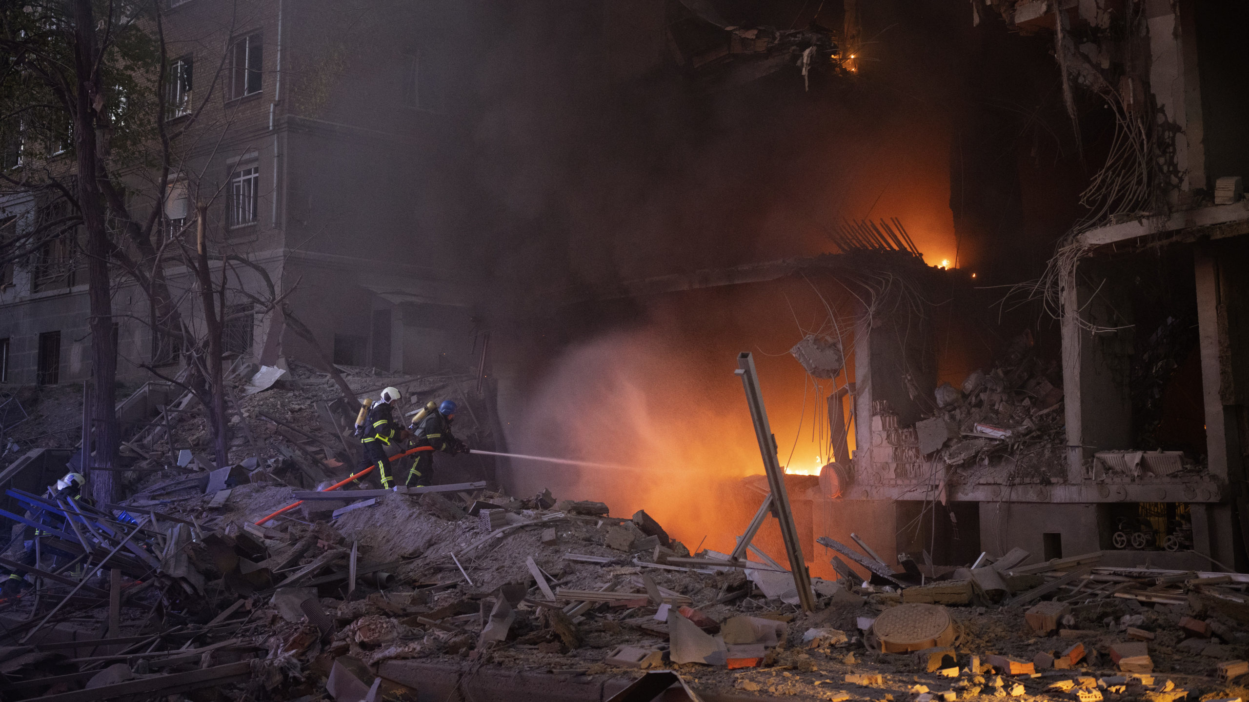 Firefighters try to put out a fire following an explosion in Kyiv, Ukraine on Thursday, April 28, 2...