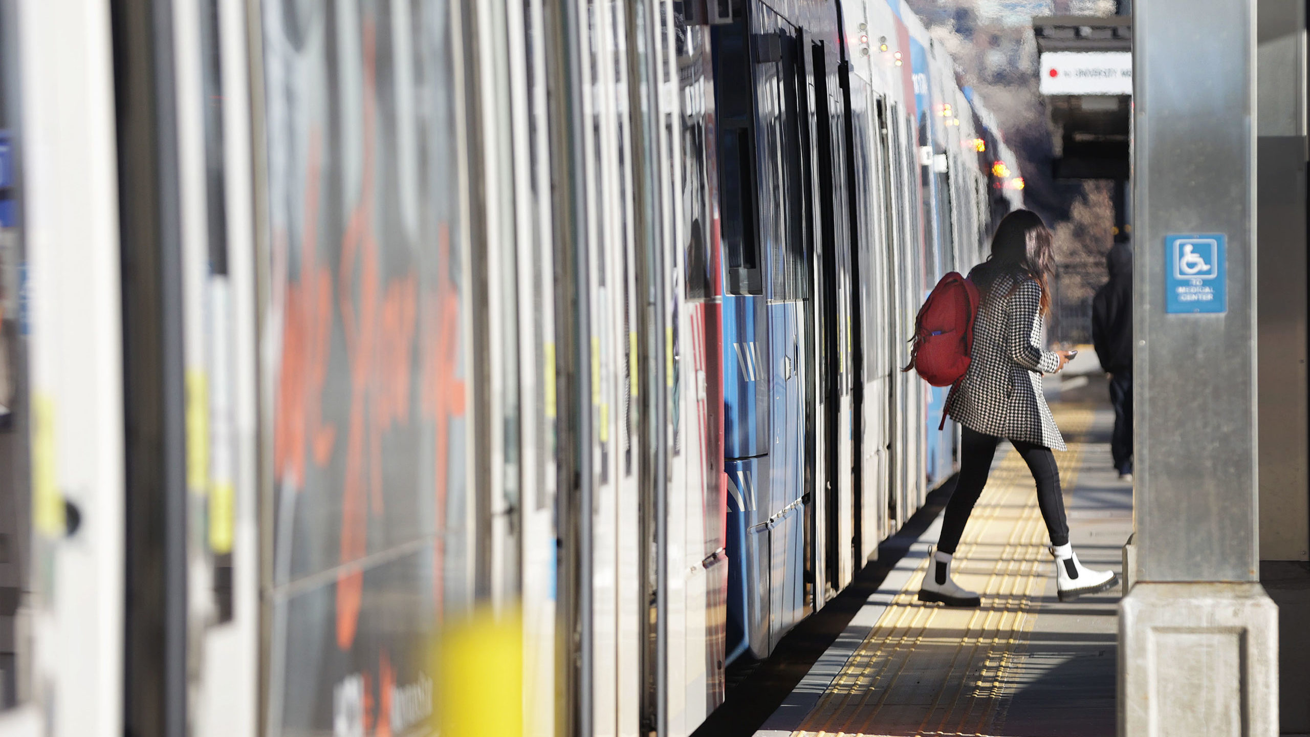 UTA passenger exits a Trax train during free fare week...