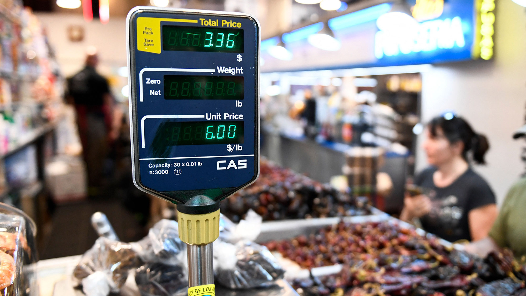A clerk weighs dried peppers for a customer inside Grand Central Market on March 11, 2022 in downto...