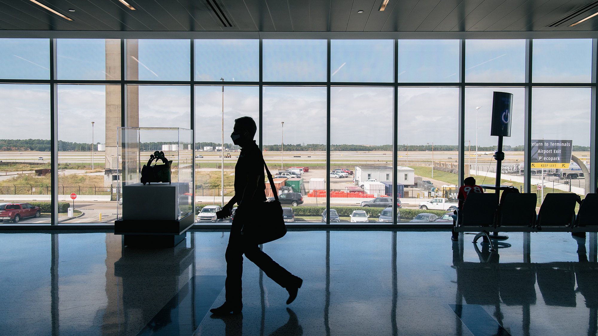A traveler walks through the George Bush Intercontinental Airport on December 03, 2021 in Houston. ...
