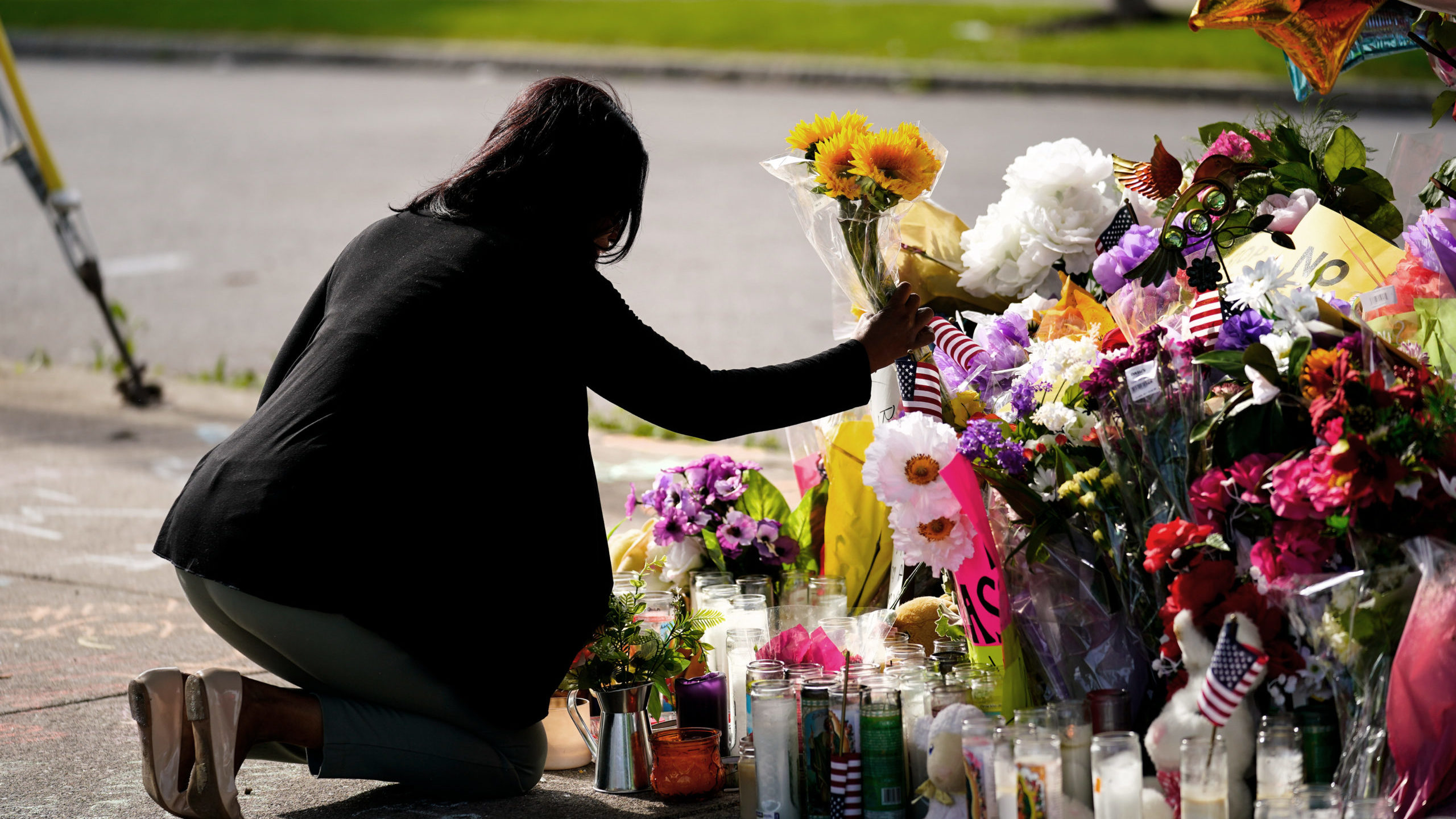 A woman at the memorial set up at the scene of the Buffalo shooting....