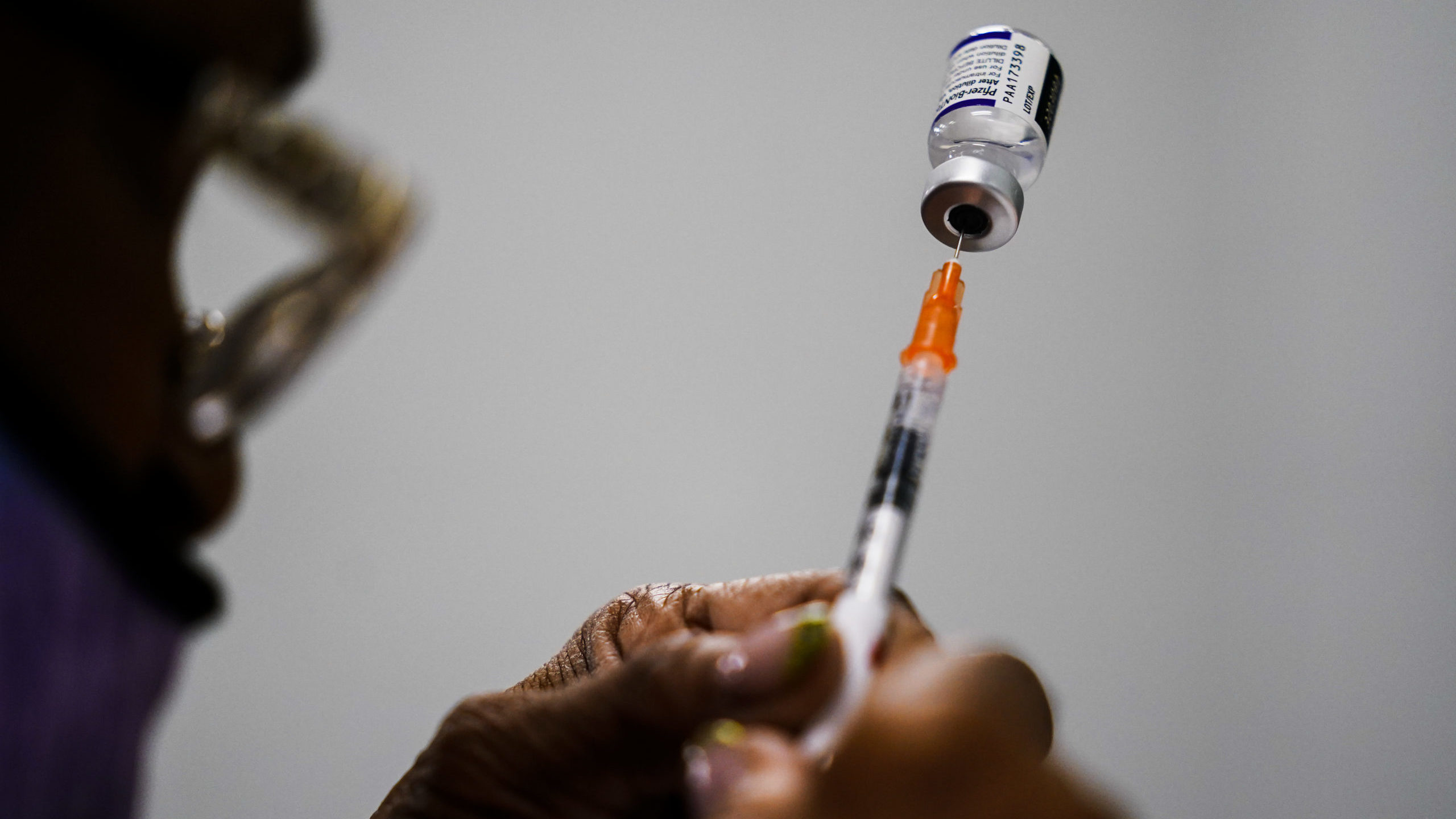 FILE - A syringe is prepared with the Pfizer COVID-19 vaccine at a vaccination clinic at the Keysto...