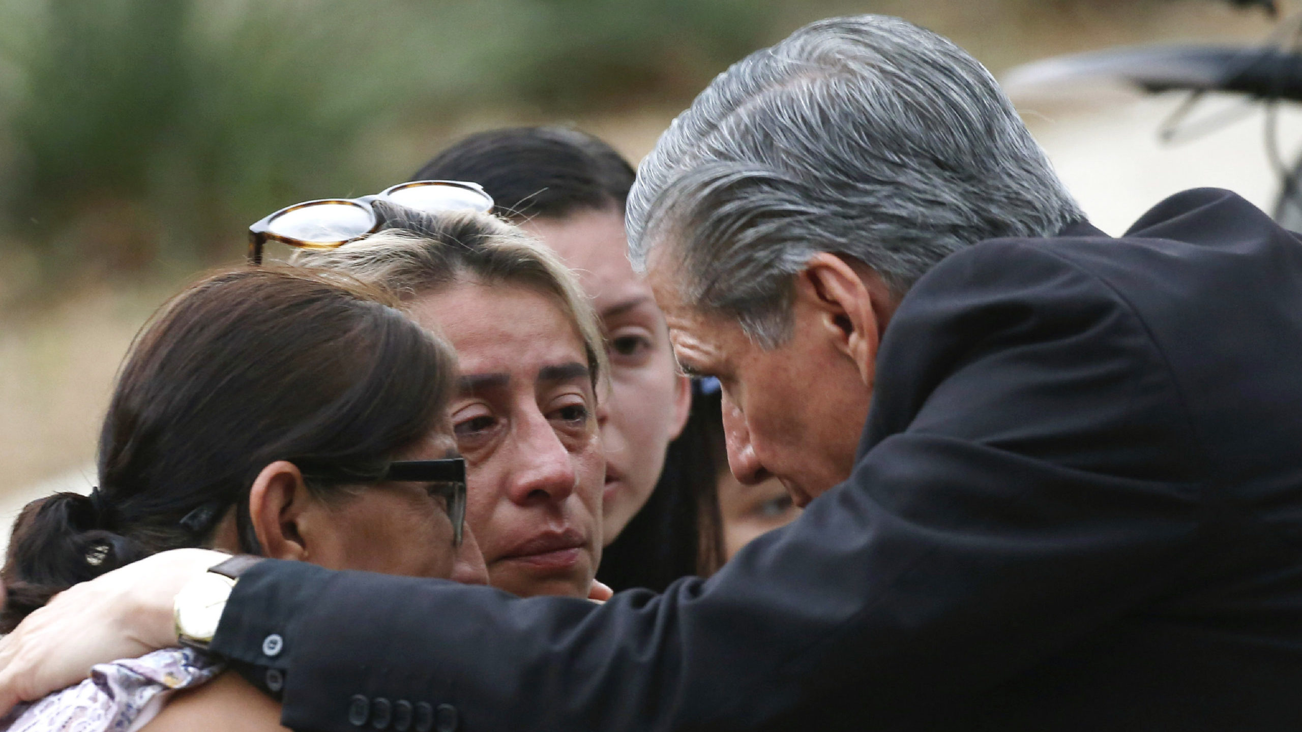 The archbishop of San Antonio, Gustavo Garcia-Siller, comforts families outside the Civic Center fo...