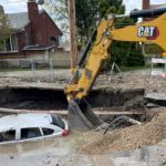 Car removed from a giant sinkhole that was created by broken water main