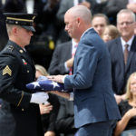 Gov. Spencer Cox, left, takes the flag that was draped over former U.S. Sen. Orrin G. Hatch’s casket to present to Hatch's widow, Elaine, during the funeral service for the late senator. Kristin Murphy, Deseret News
