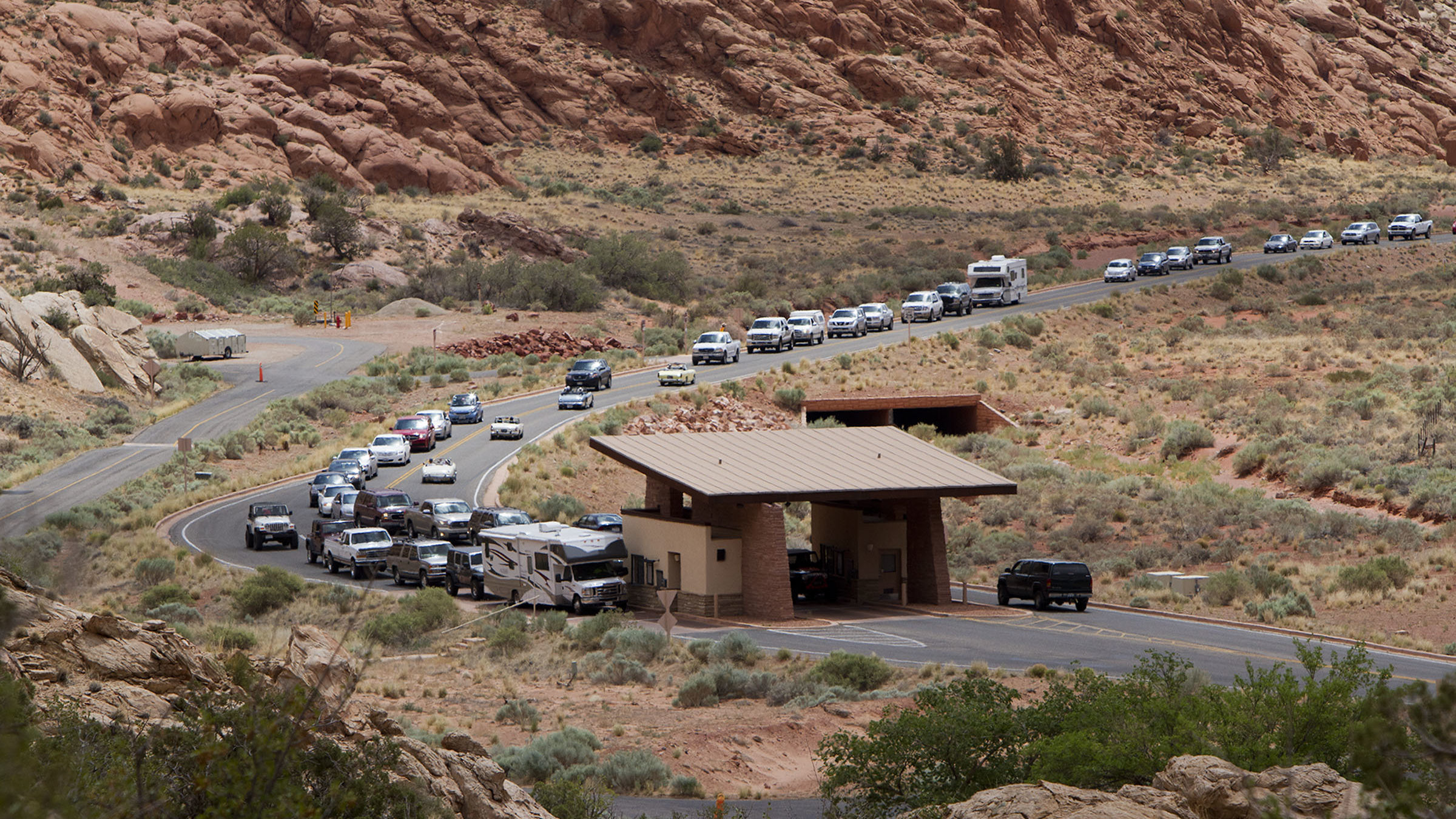 Cars line up at an entrance, memorial day weekend travel is expected to cause traffic build up....