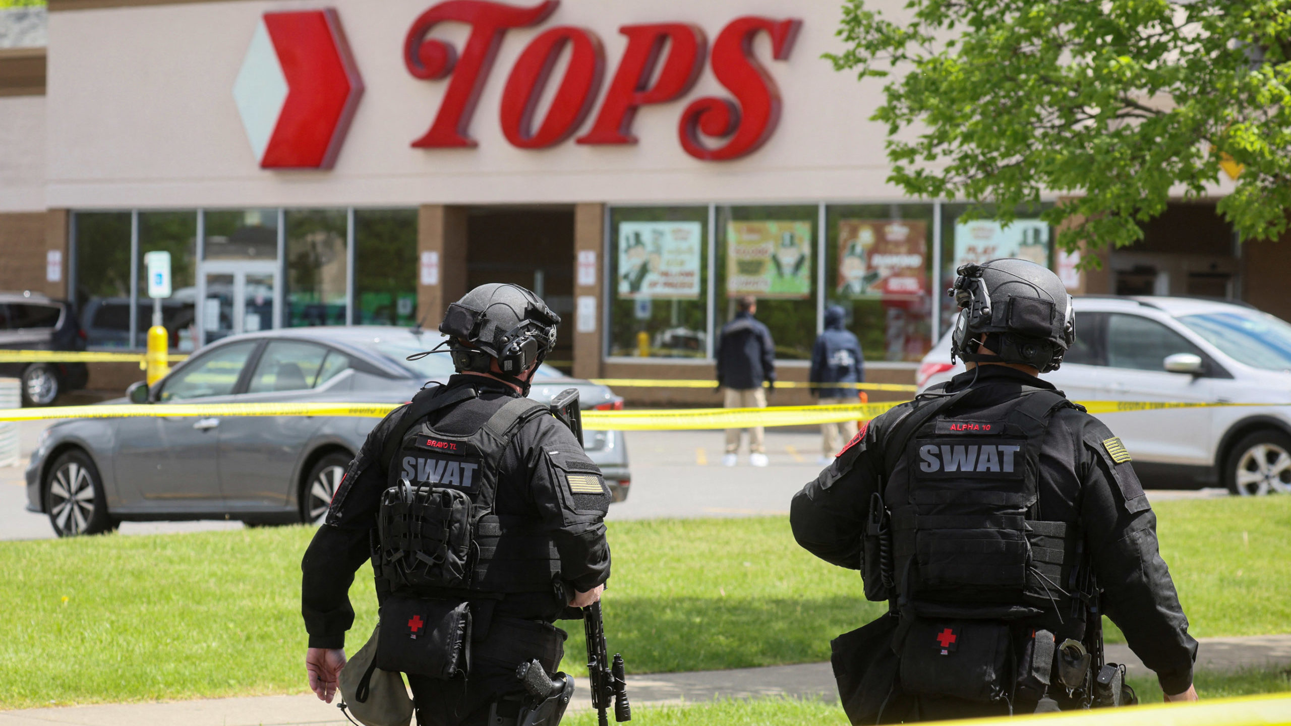 Members of the Buffalo Police department work at the scene of a shooting at a Tops supermarket in B...