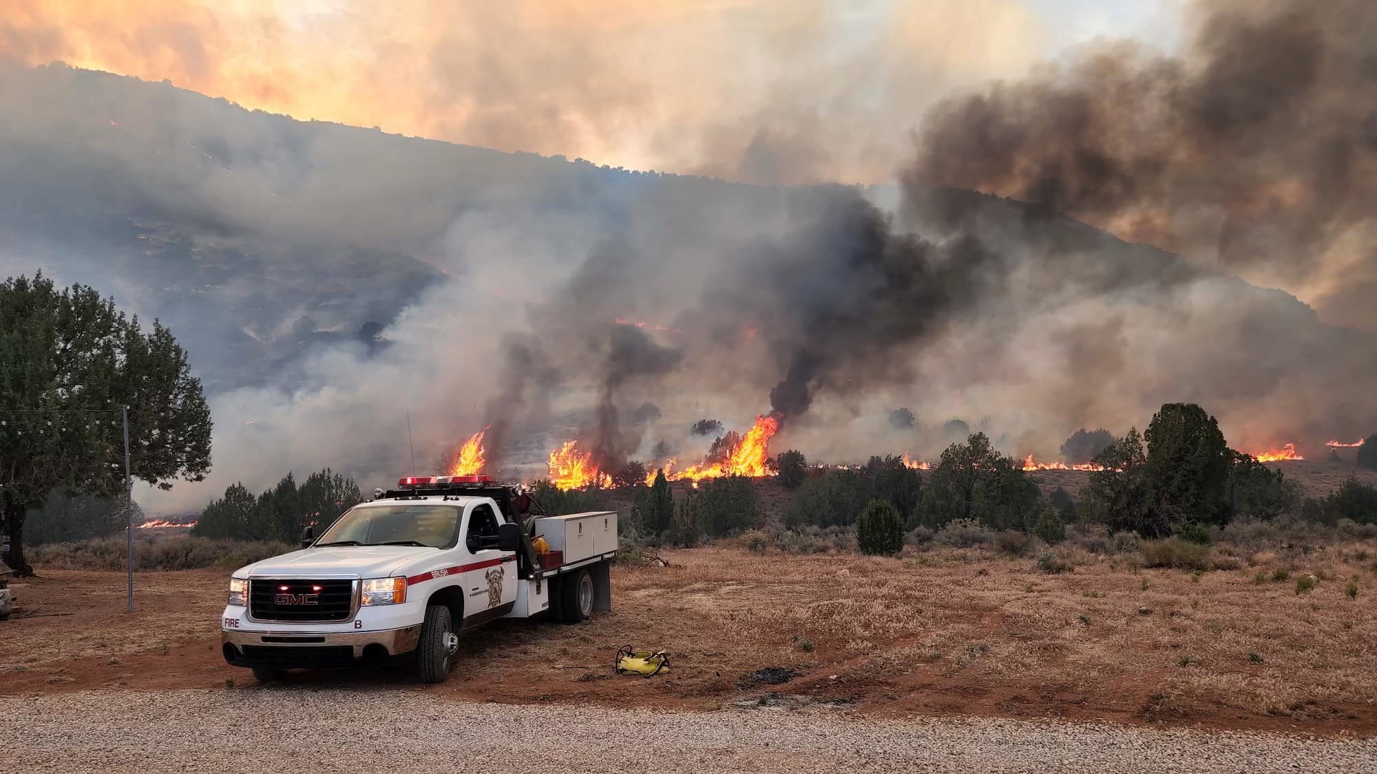 A picture of the Dalton Wash Fire blazing behind a truck...
