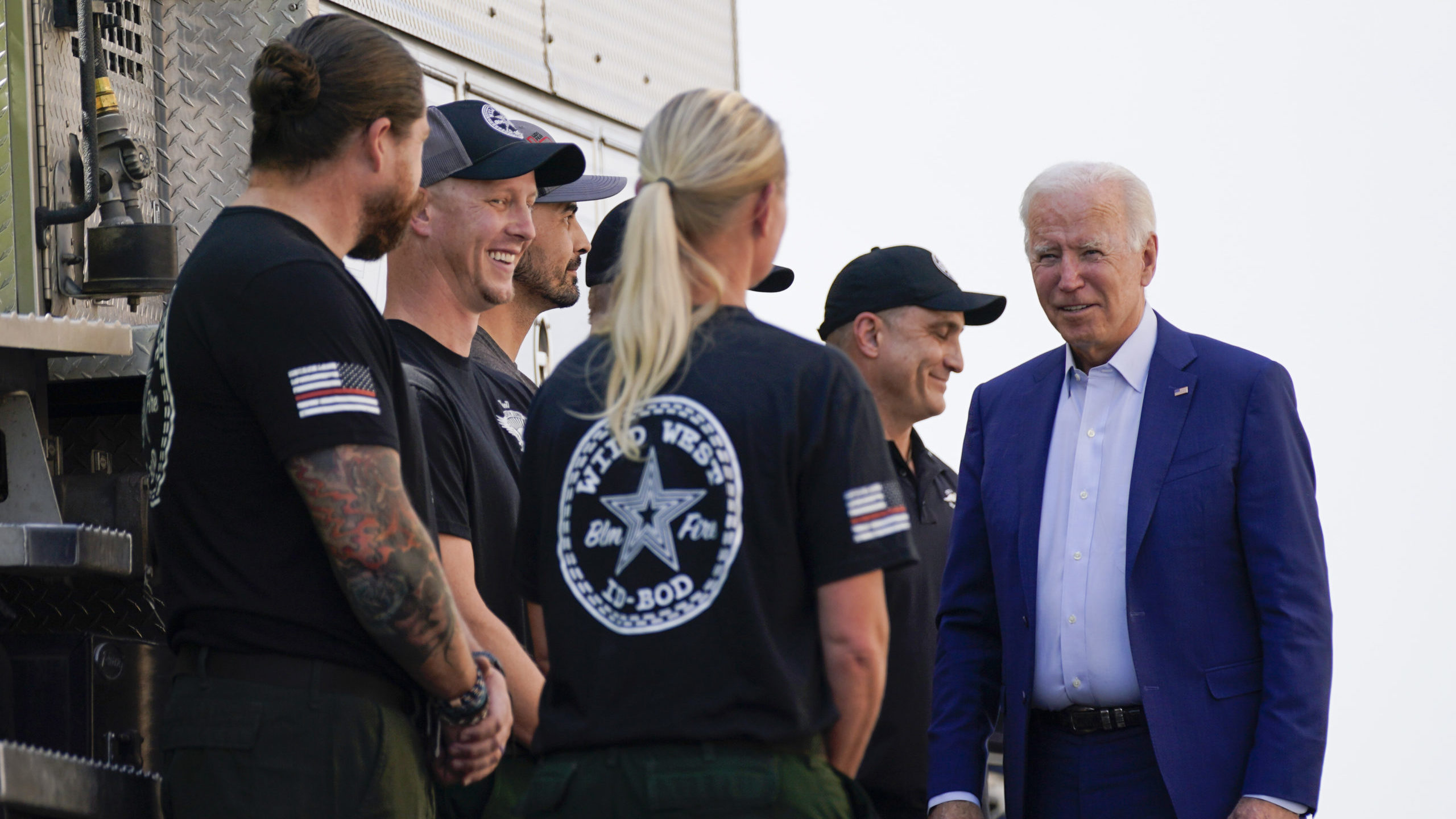 FILE - President Joe Biden greets firefighters as he tours the National Interagency Fire Center, Se...