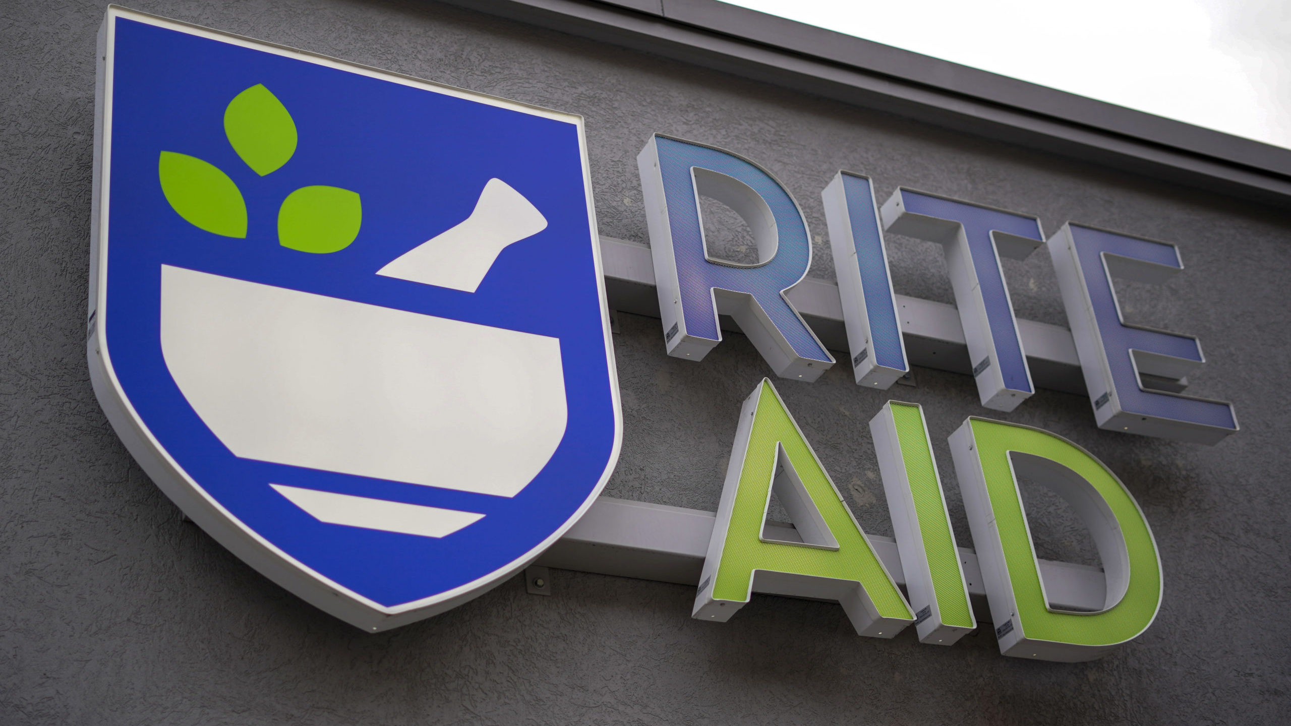 A Rite Aid logo is displayed on its store...
