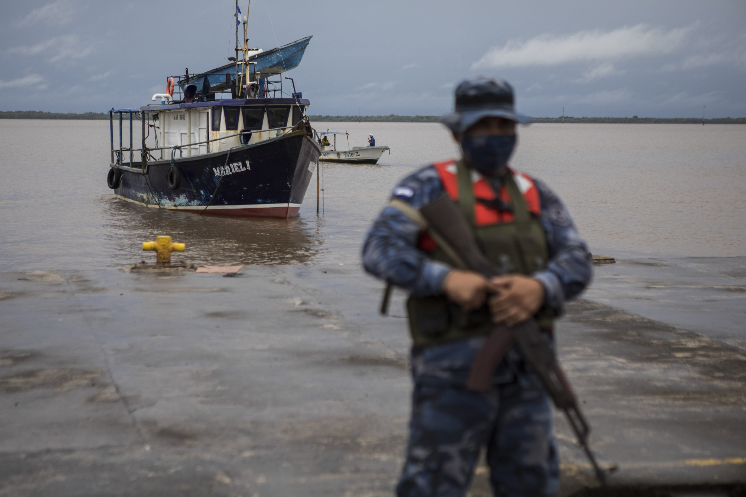 A Navy soldier stands guard as authorities wait for the arrival of people who were evacuated from t...