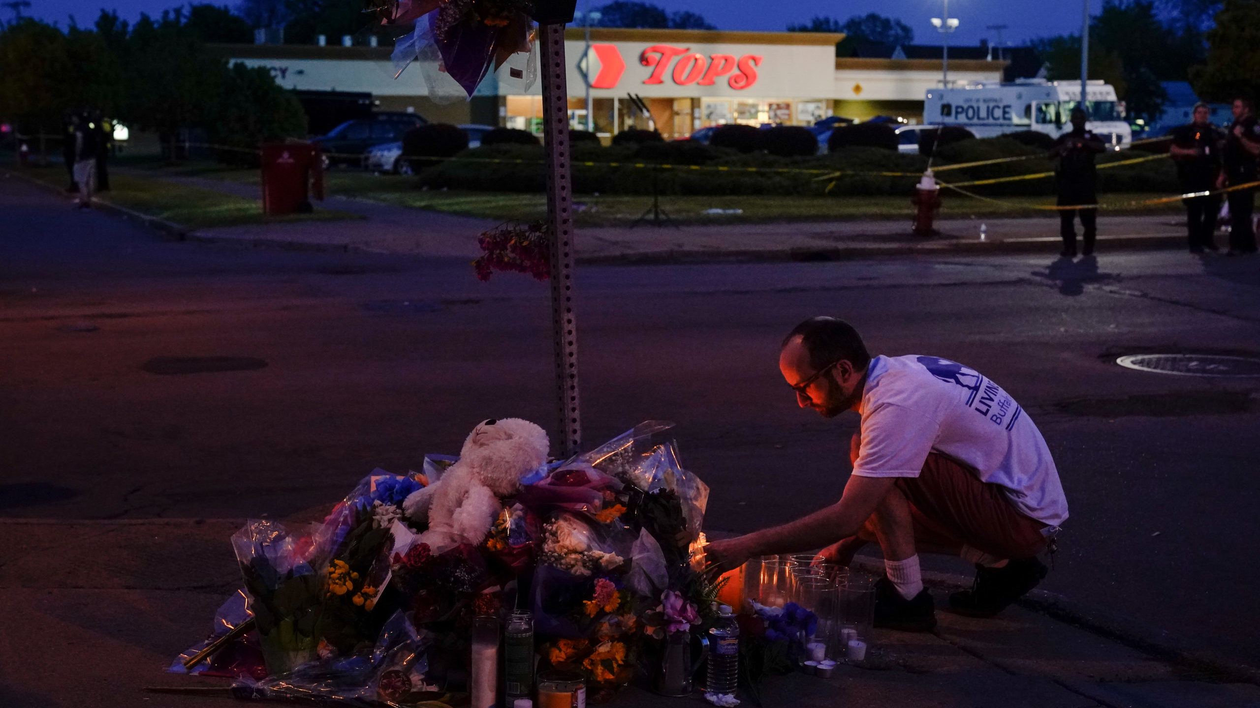 A man next to a memorial in front of Tops Friendly Market where the Buffalo shooting took place....