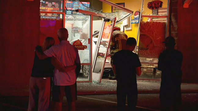 A delivery driver was injured after a vehicle crashed into the lobby of Big Daddy's Pizza in Sandy....