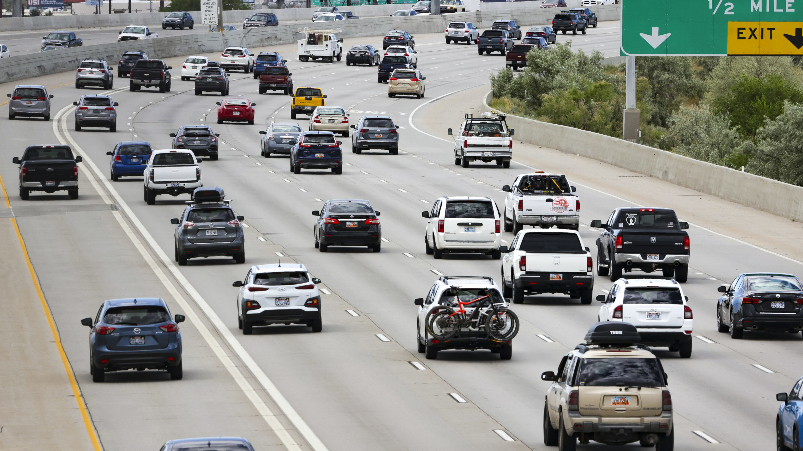 Traffic moves alone an interstate. Transportation costs eat up Utahn's paycheck according to new da...