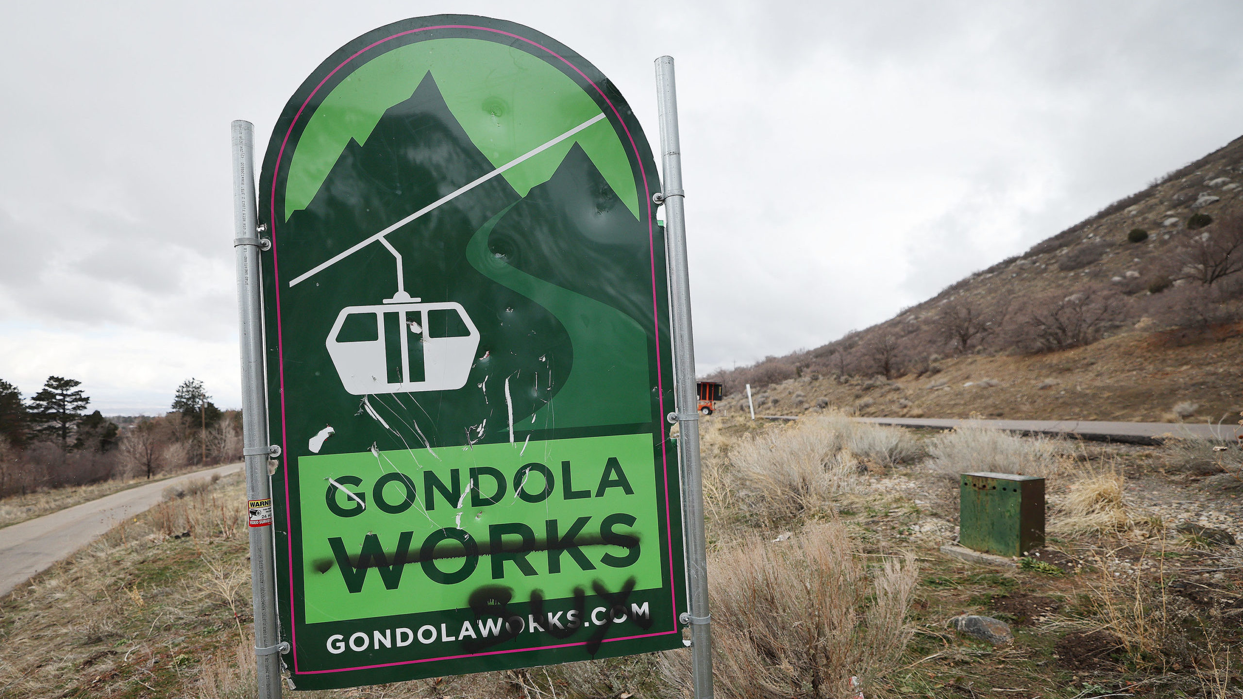 A Gondola Works sign that has graffiti on it in is pictured near Little Cottonwood Canyon on Wednes...