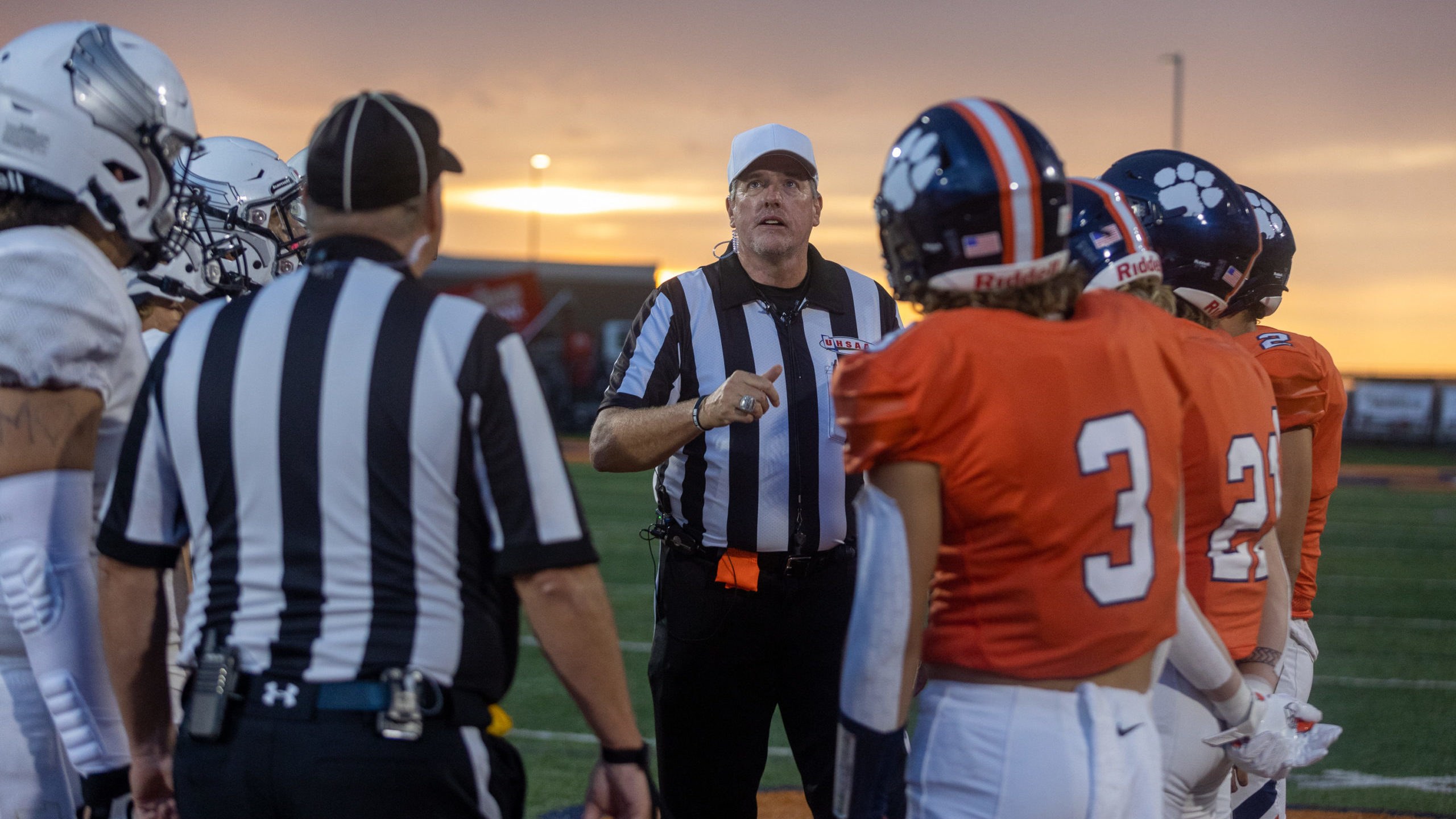 A referee tosses a coin before a football game between Brighton and Desert Hills in Cottonwood Heig...