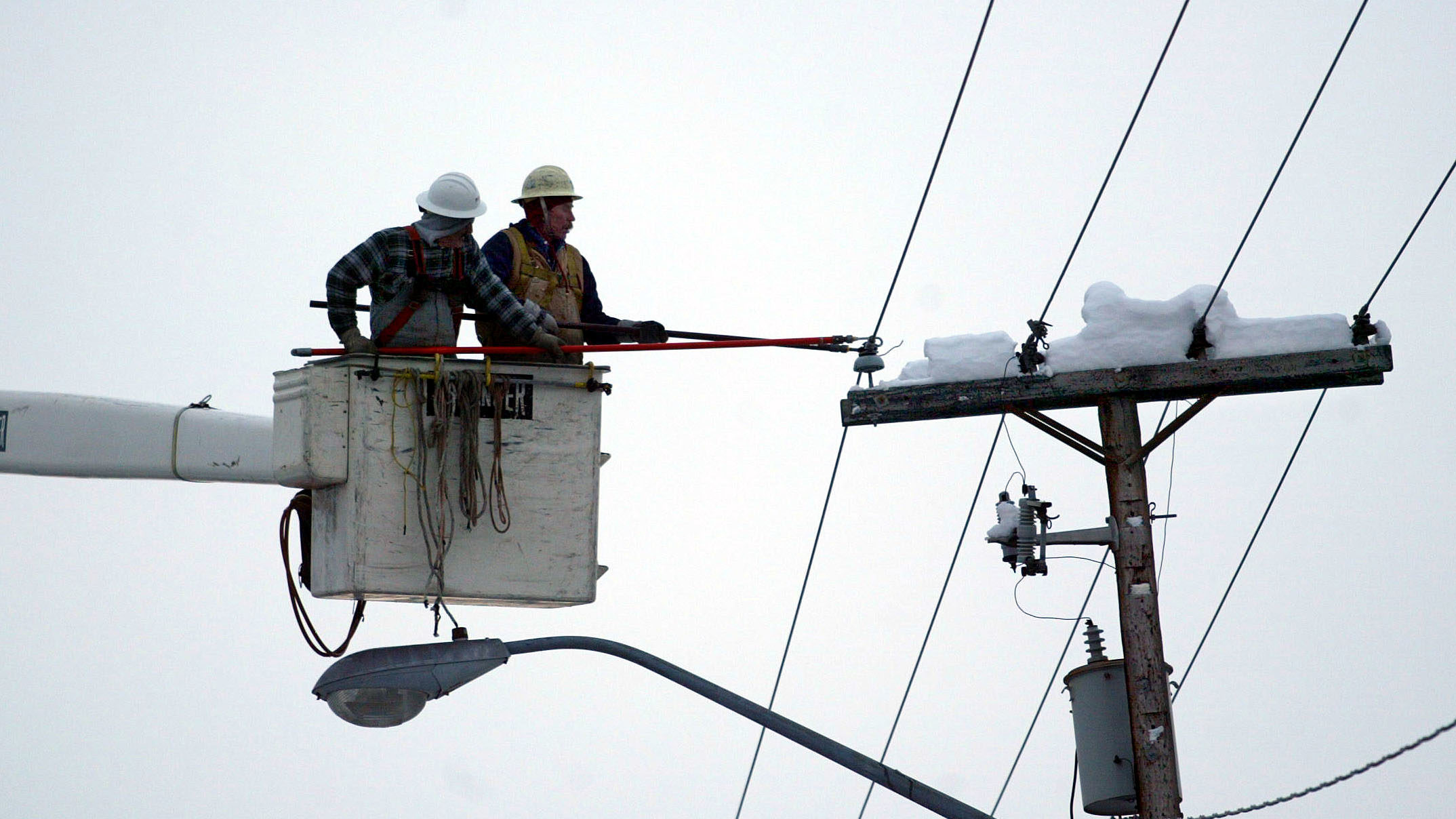 Two men work on a power outage, a power outage in sandy was caused by vandals...