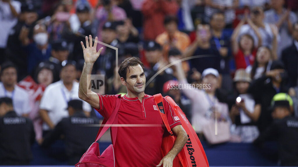 FILE - Roger Federer of Switzerland waves to spectators as he leaves the court after he lost to Ale...