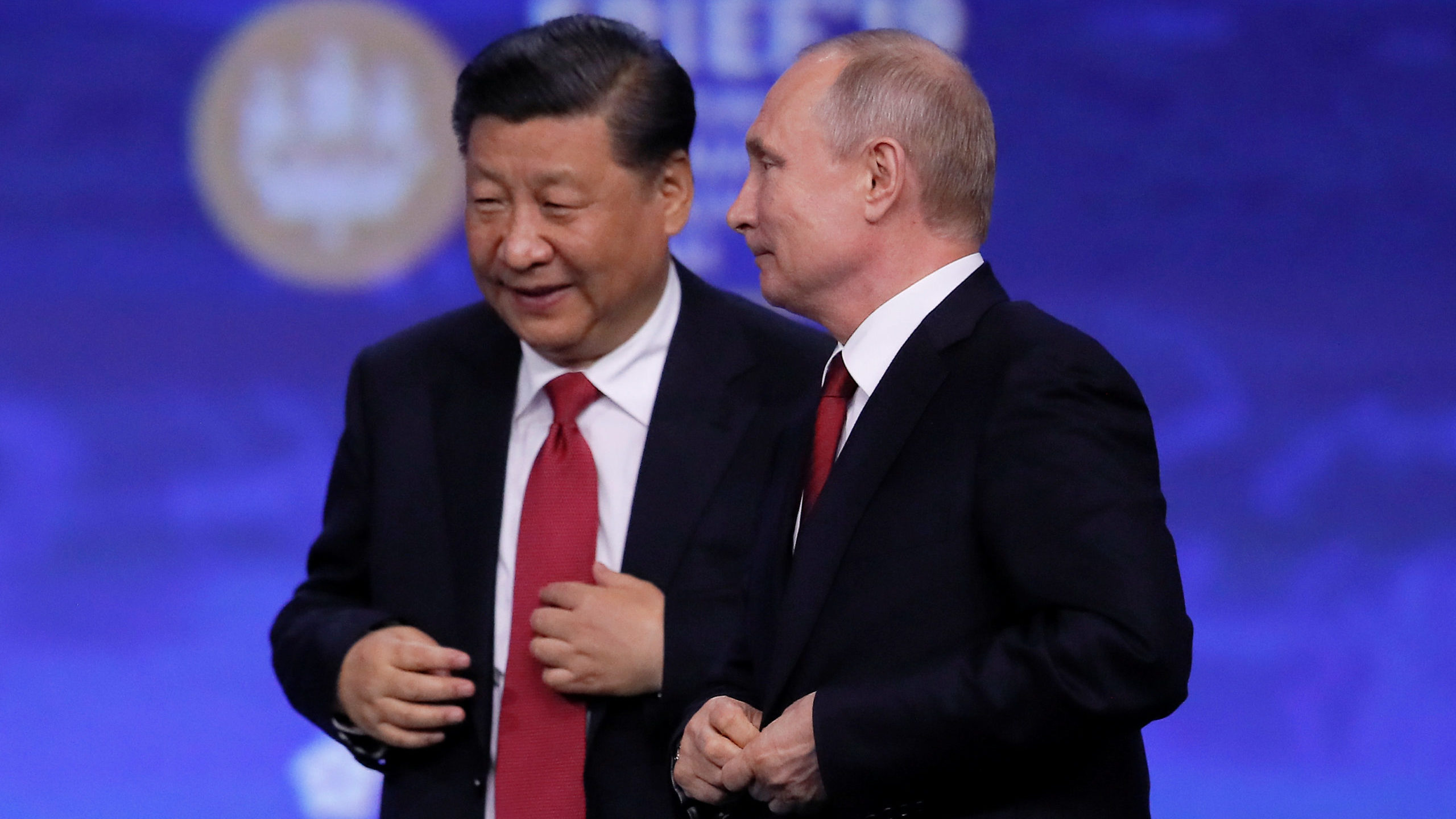 Chinese President Xi Jinping (L) and Russian President Vladimir Putin leave after a session of the ...