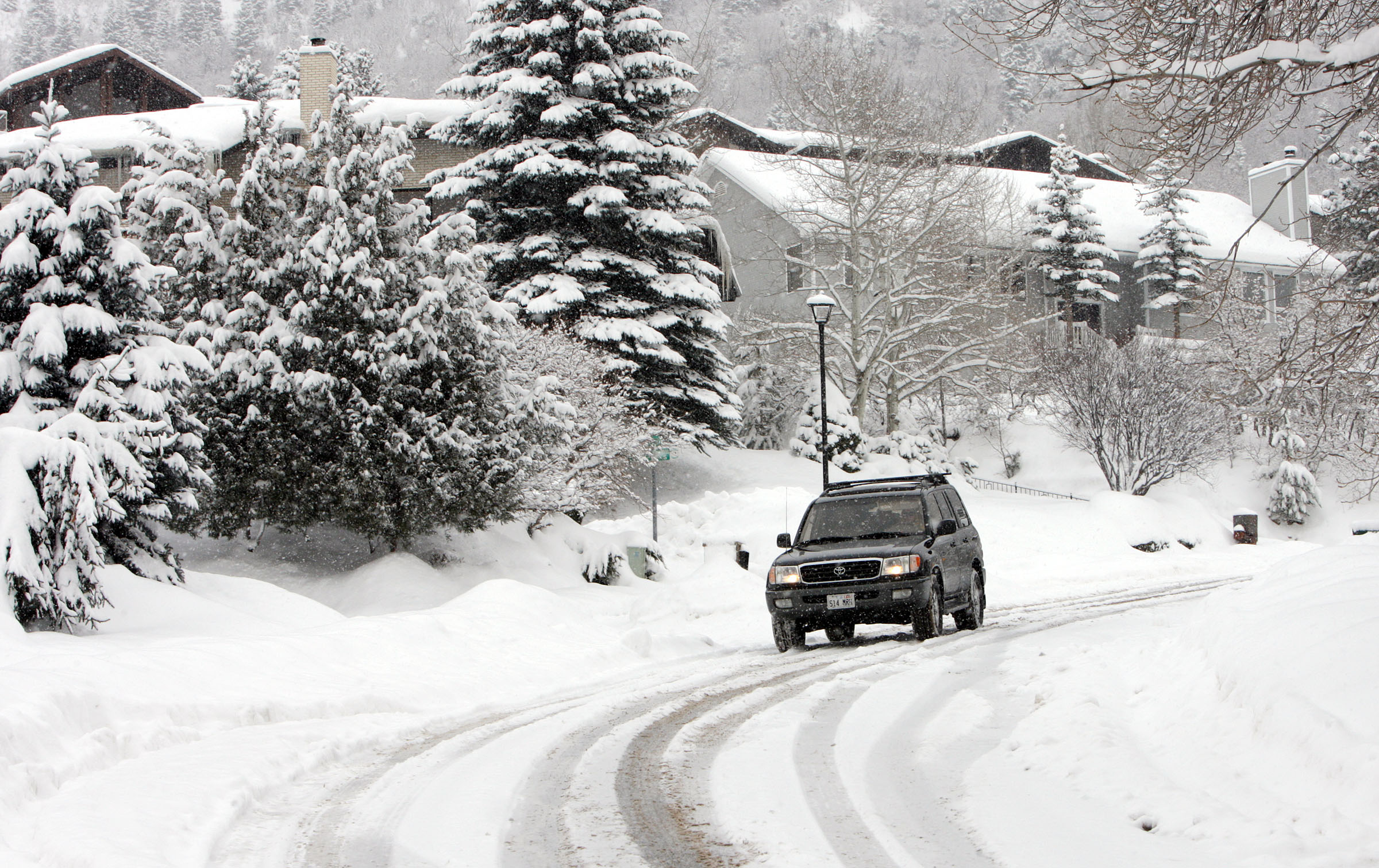 A motorist drives through the snow in Olympus Cove in Salt Lake County. (Jeffrey D. Allred, Deseret...