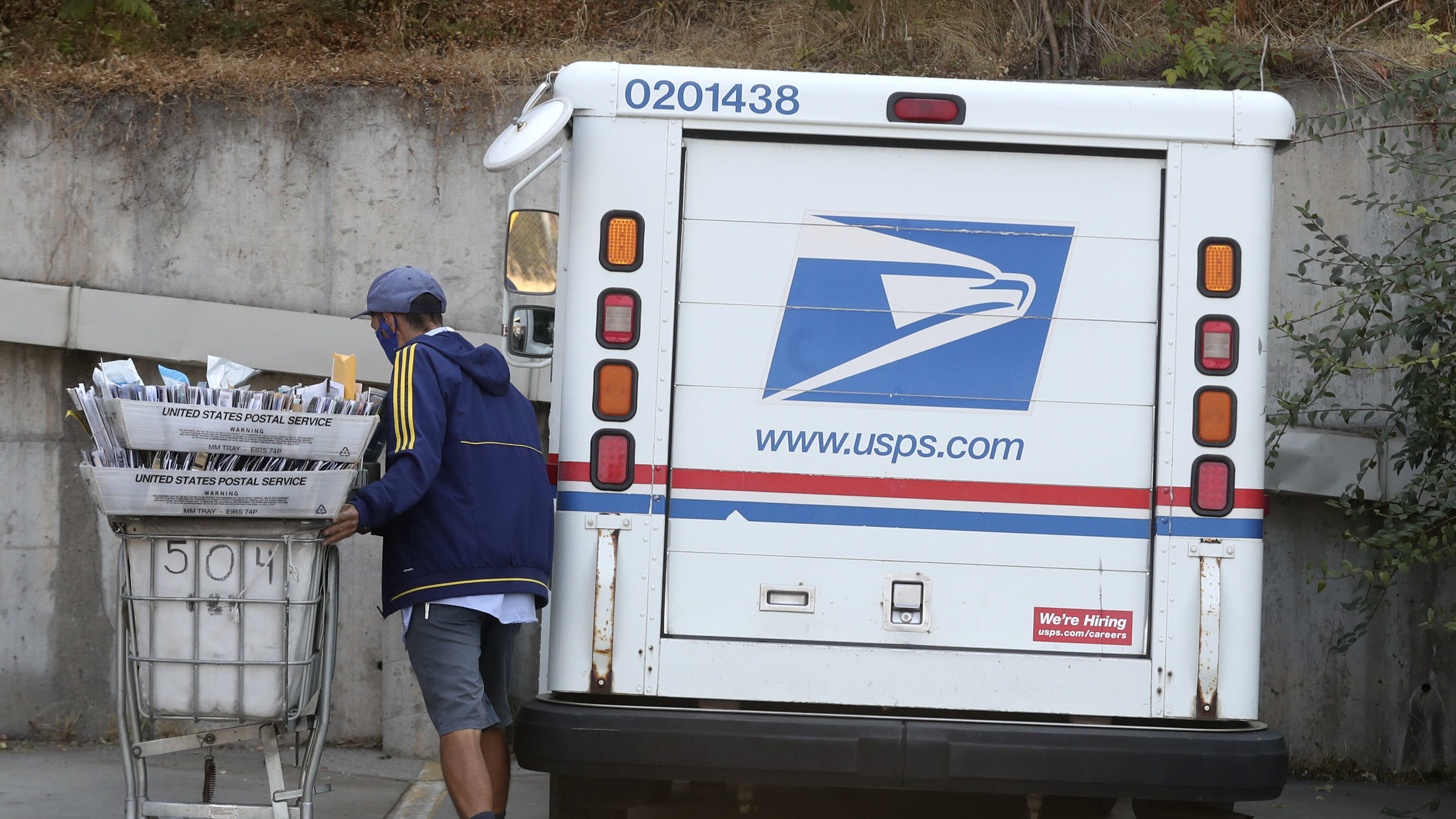 Carrier at USPS mail truck, USPS is holding a job fair...