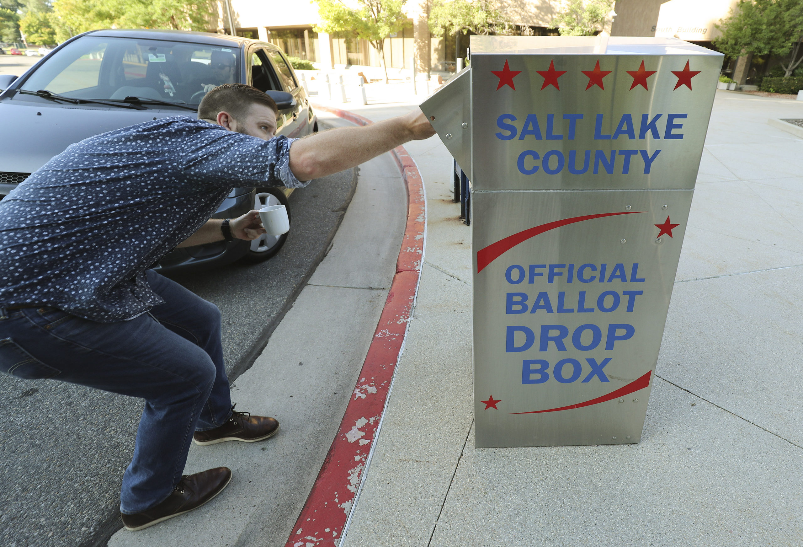 Patrick Kilbourn drops off his mail-in ballot at the Salt Lake County Government Center  in Salt La...