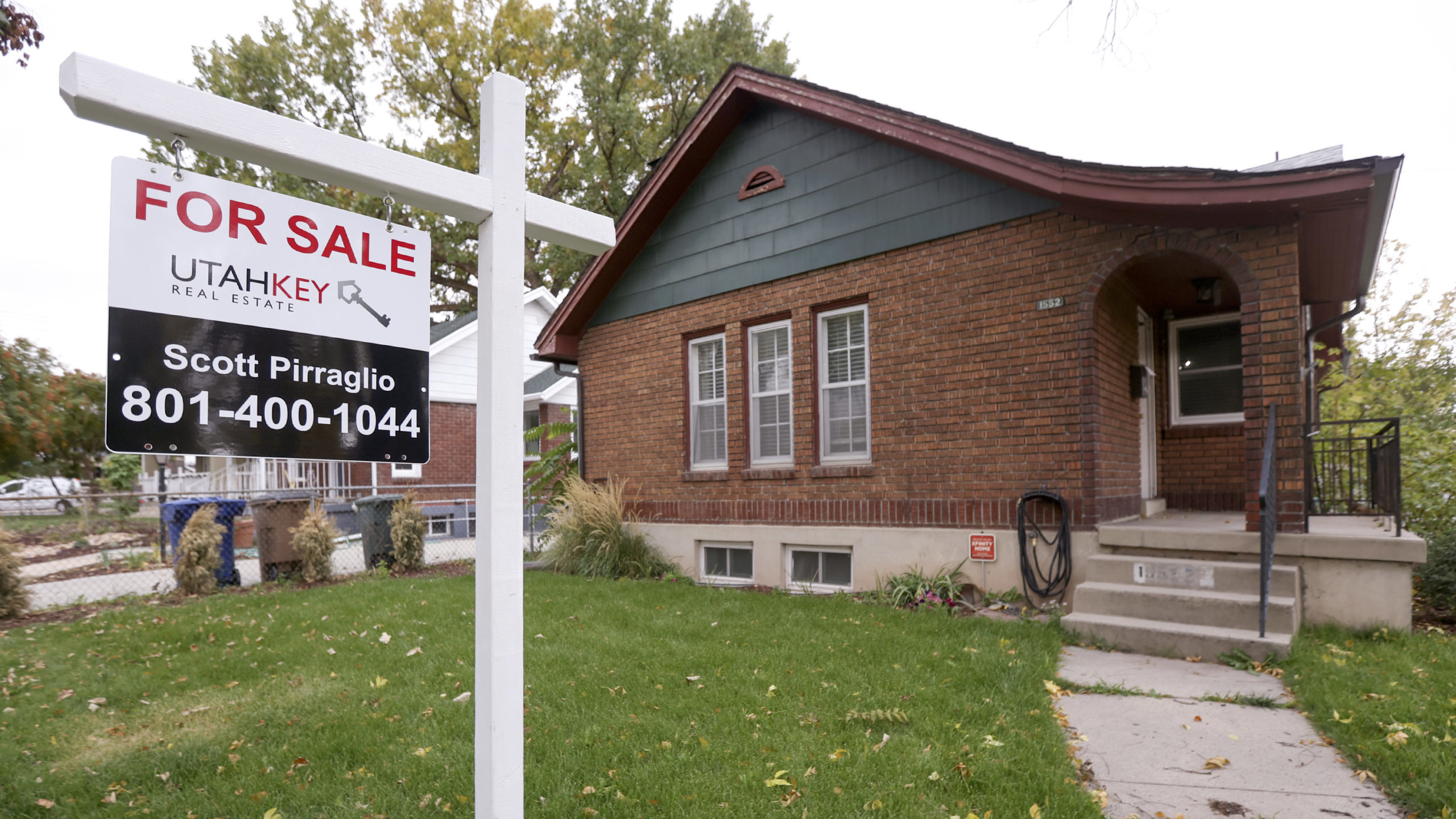 a "for sale" sign is pictured in front of a house, the average homebuyer age is rising...