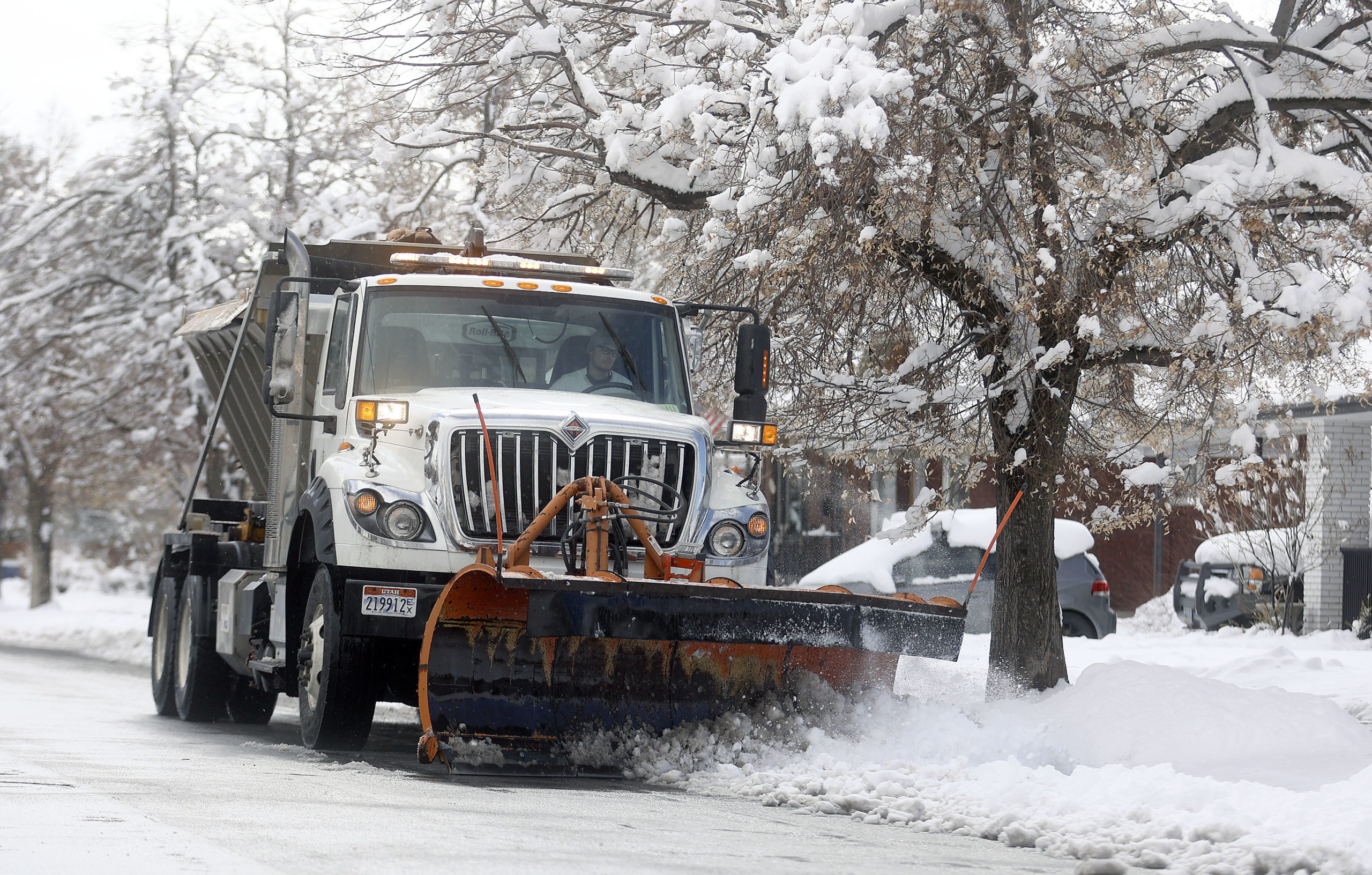 A plow truck driver plows after a snowstorm in Salt Lake City on Wednesday, Feb. 17, 2021....