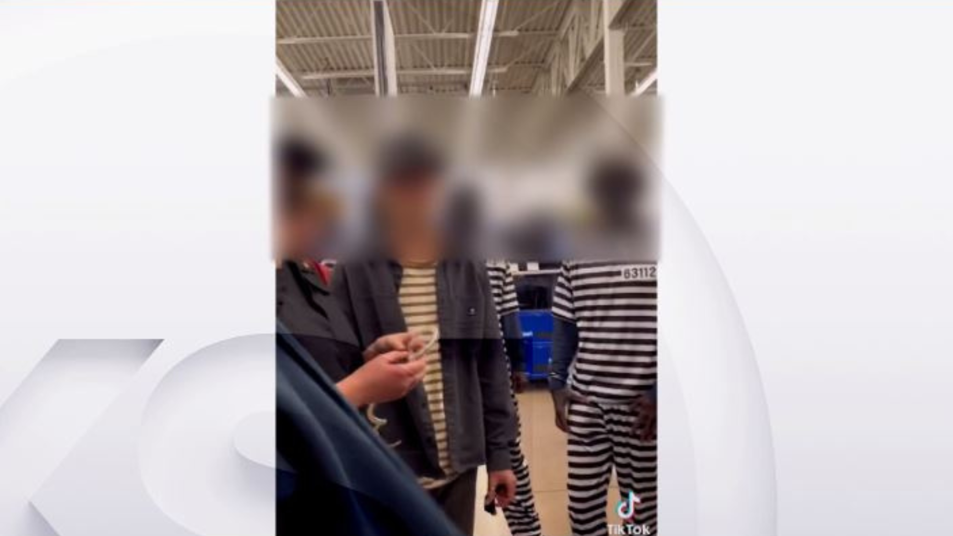 Screen shot taken from a video that shows three young people dressed in blackface and prison outfit...