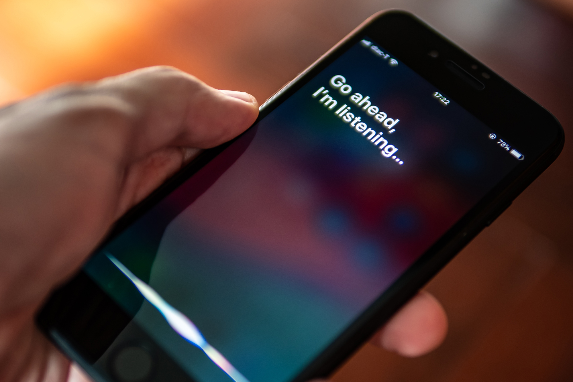 Image of a cell phone receiving a voice command and Siri answering....