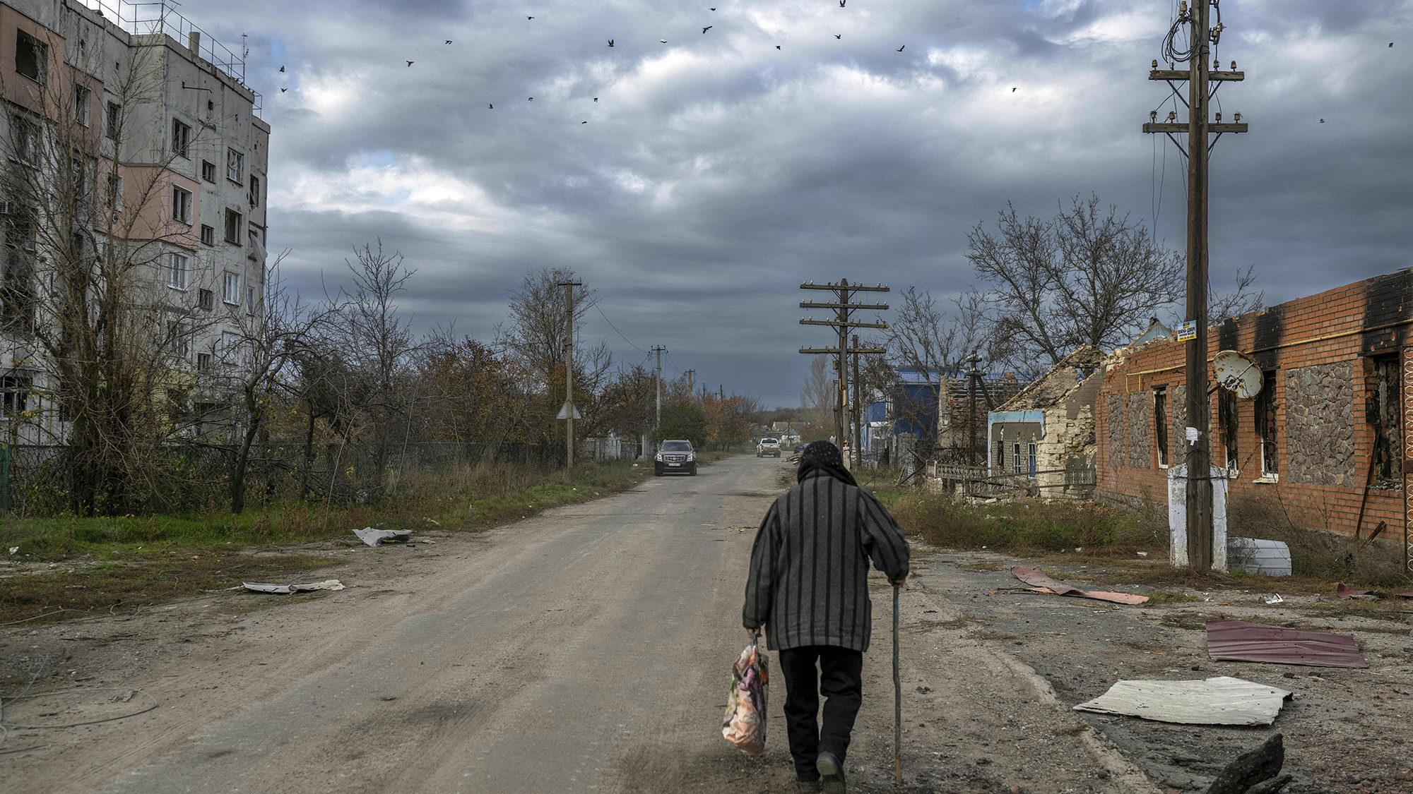 An old woman walks in the Kherson region village of Arkhanhelske on Nov. 3, 2022, which was formerl...