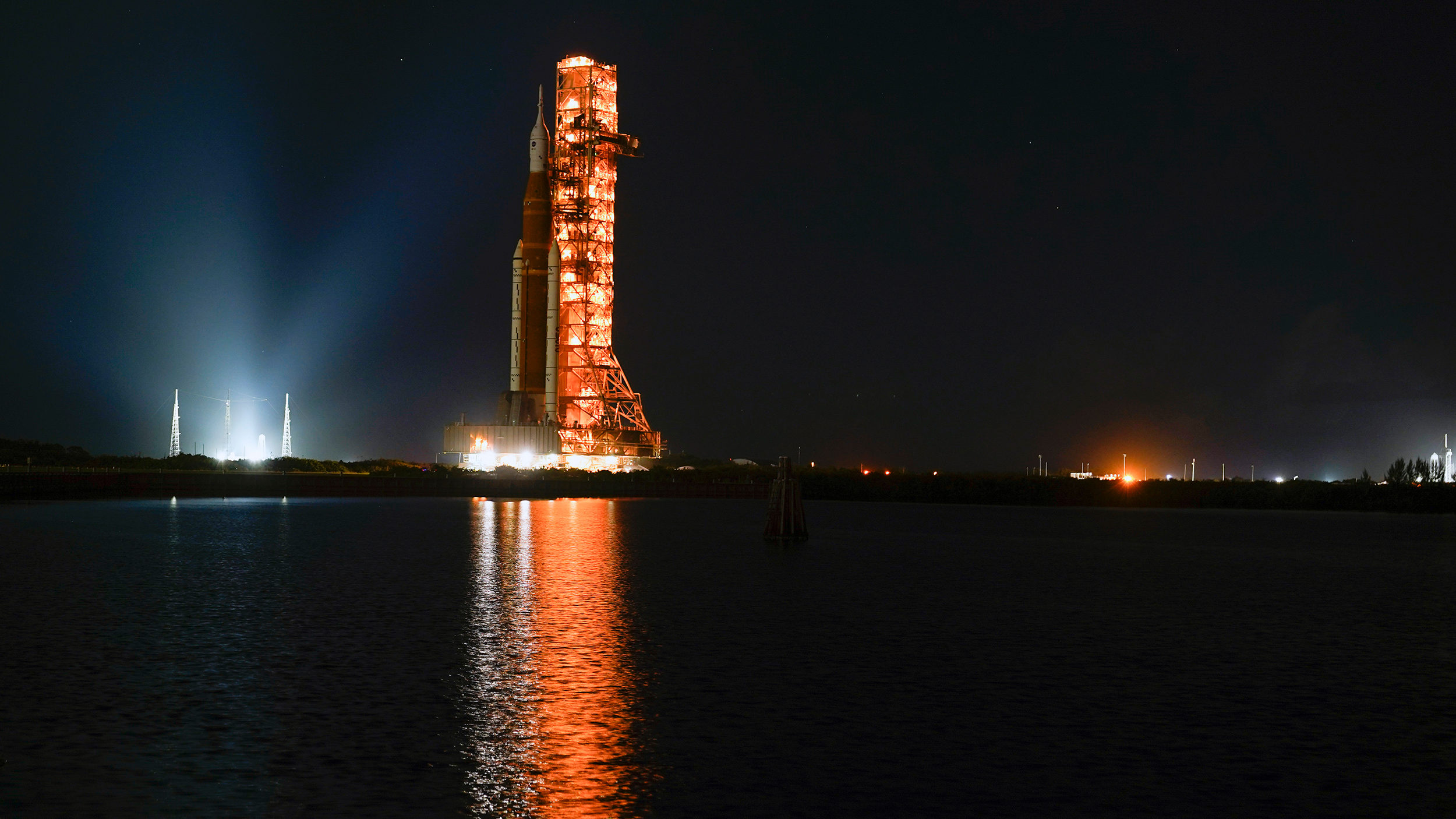 The NASA Space Launch System rocket makes its way from the Vehicle Assembly Building to its launchp...