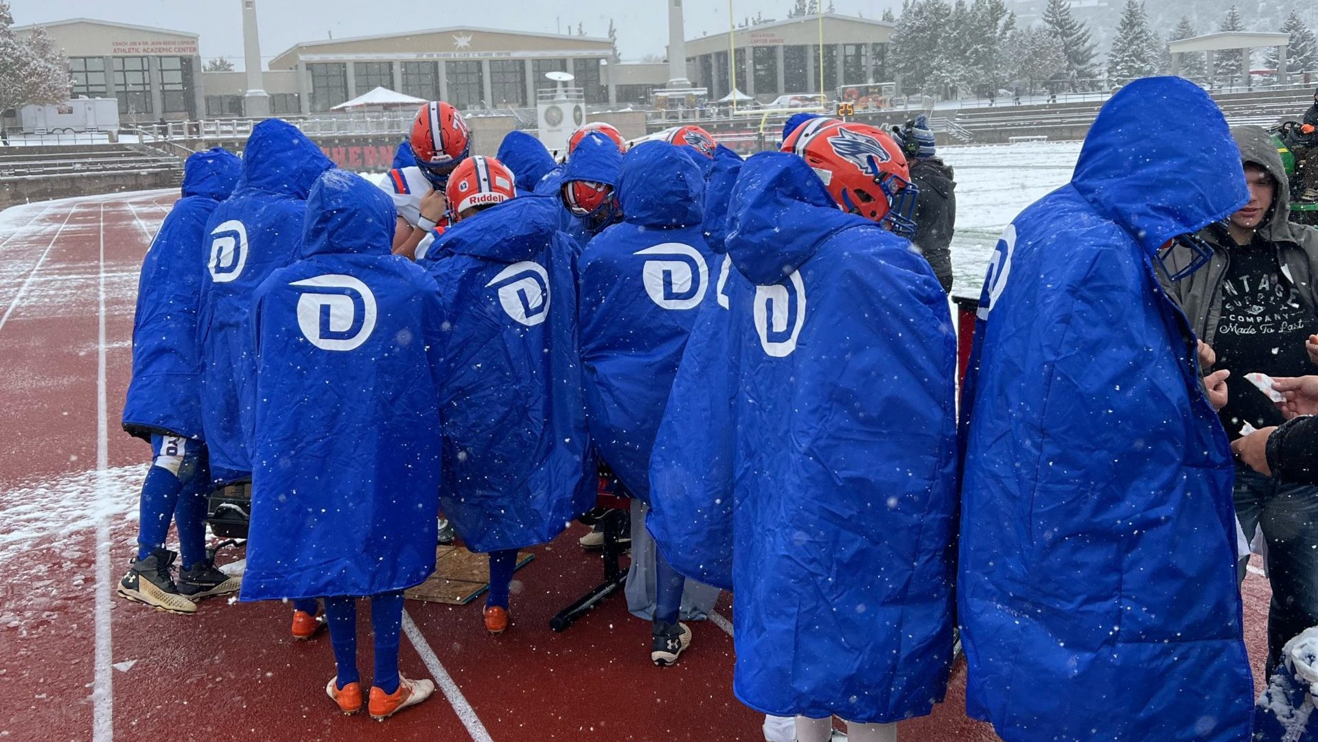 Water Canyon High School footbal players stay warm using Dixie High School football teams cold weat...
