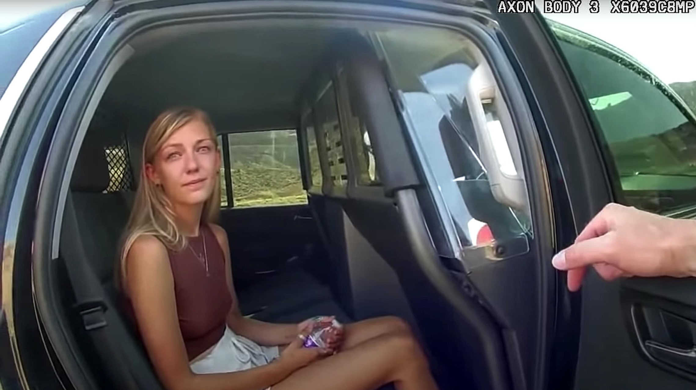 Gabby Petito is pictured in a car, her family just filed a lawsuit against moab police...