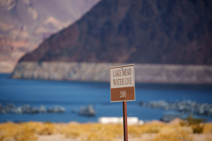 A sign at the Hemenway Harbor launch ramp marks the water line at Lake Mead in 2000, contrasting wi...