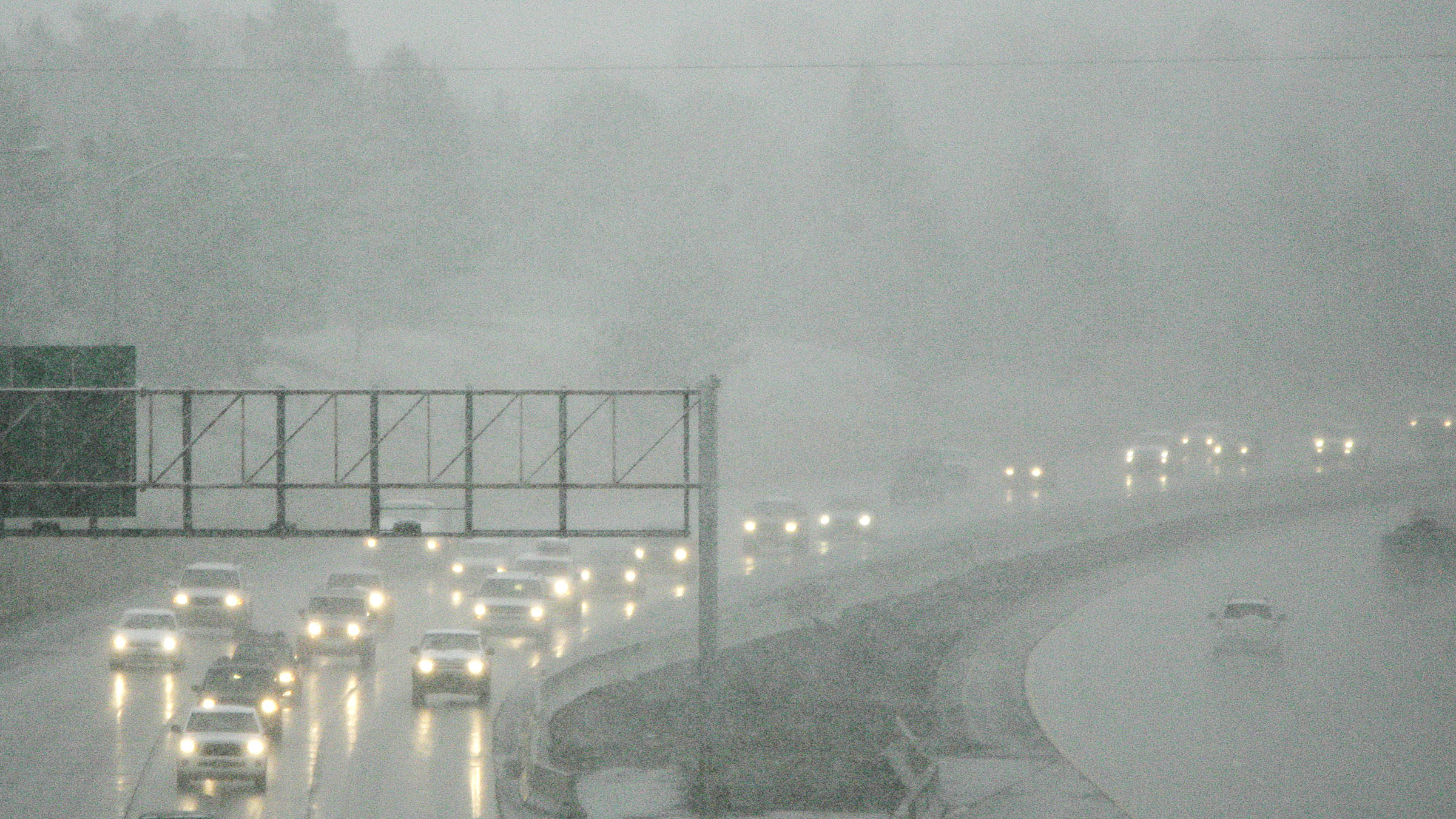 Commuters drive through the snowy conditions on Interstate 80 in Salt Lake City, Utah, Wednesday, M...
