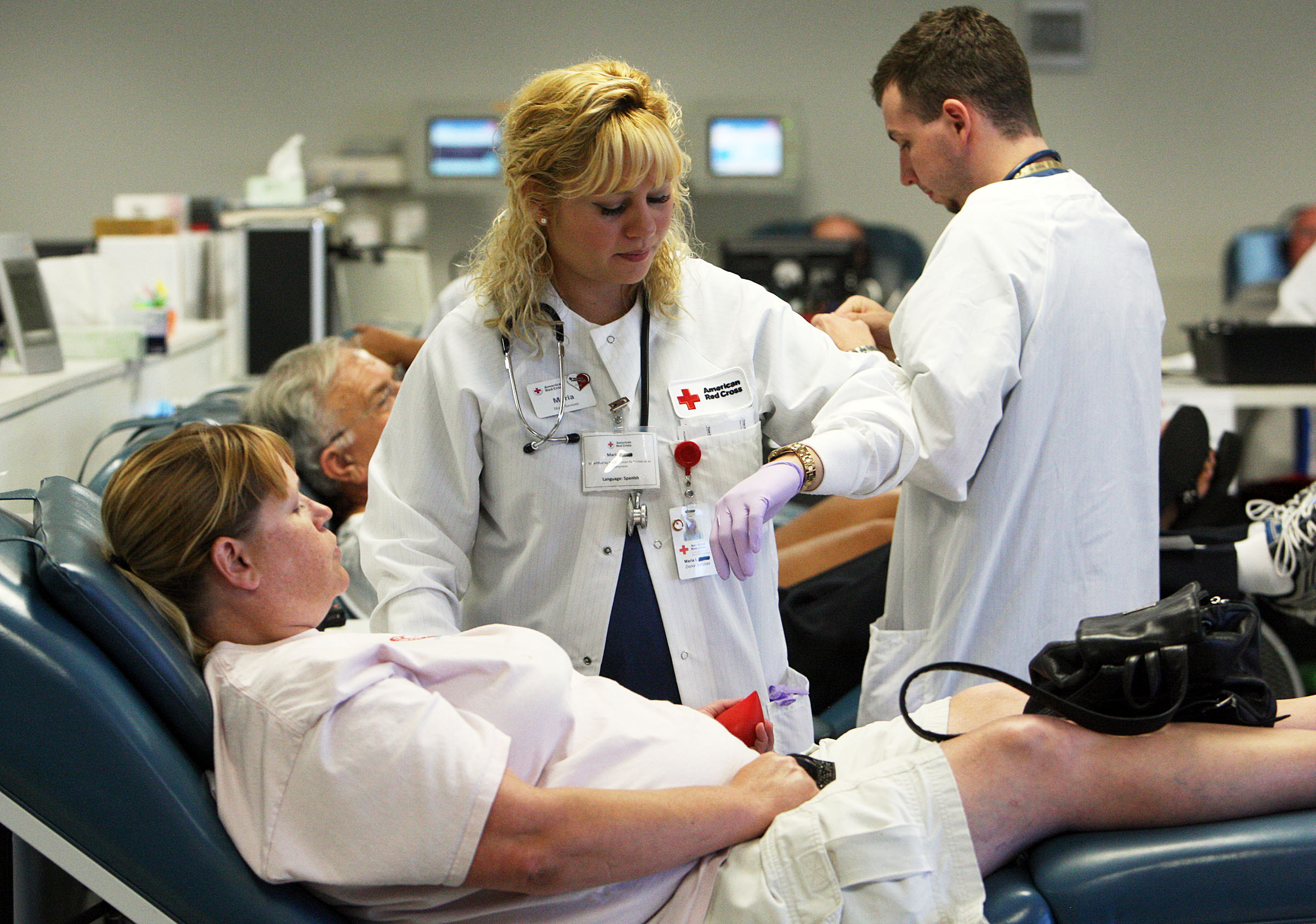Maria Figueroa of American Red Cross prepares Debbie Rhodes for blood donation in Salt Lake City, T...
