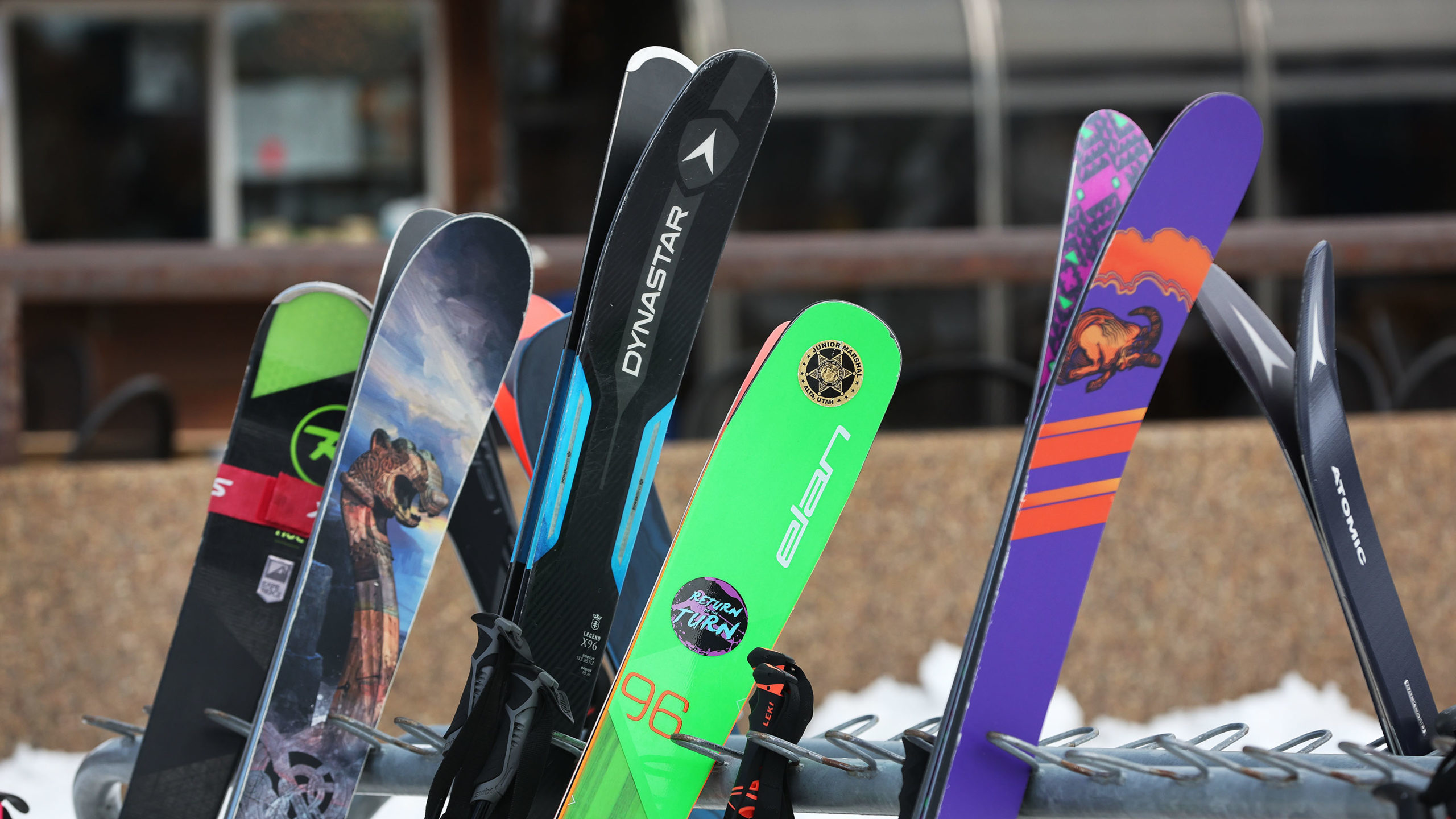 skis, which use ski wax, are pictured standing up in a storage area...