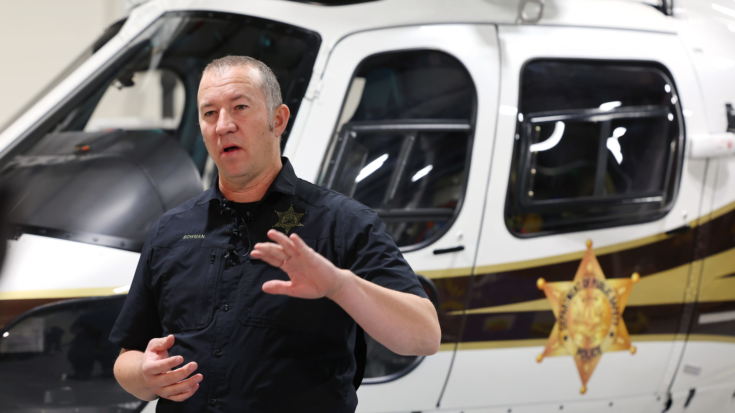 Utah Department of Public Safety pilot Luke Bowman talks with media about the mission to rescue peo...