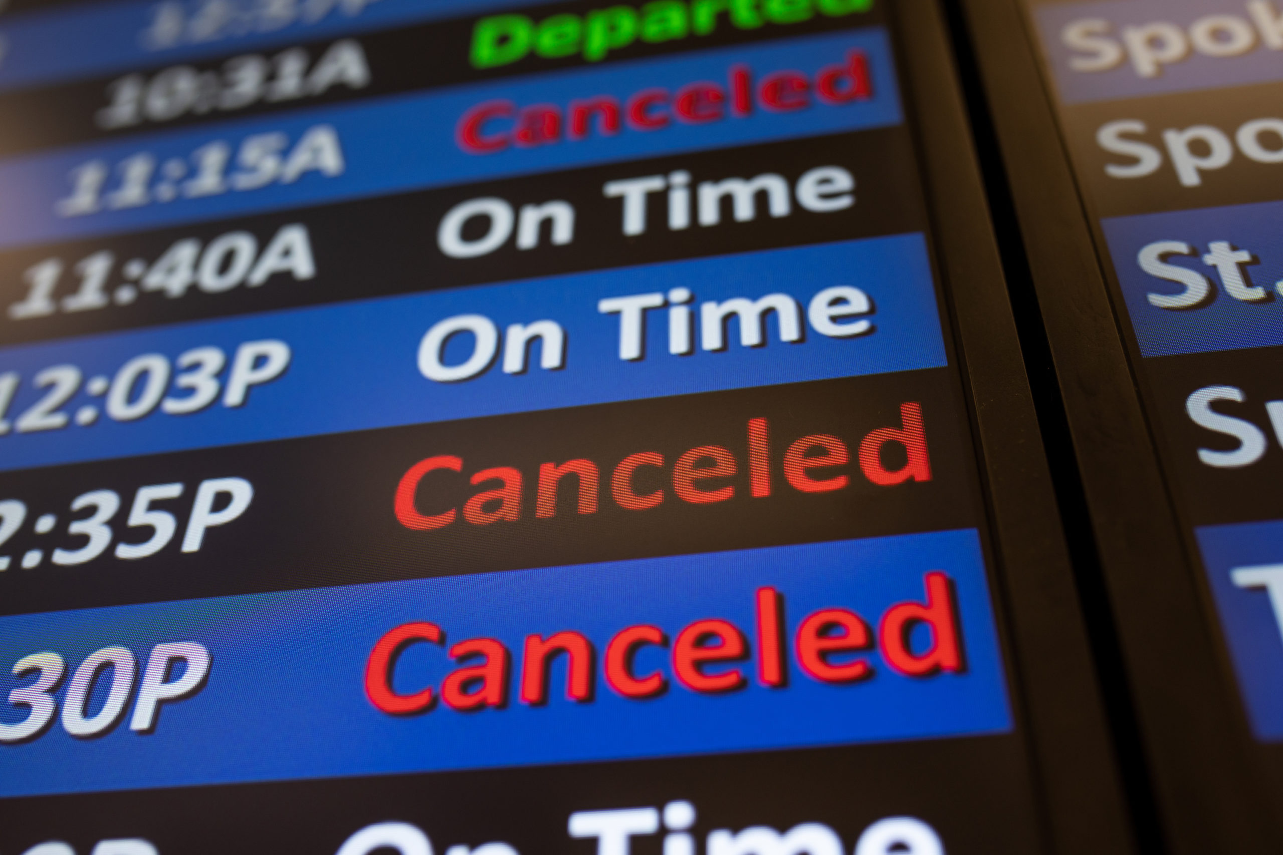 A digital display shows several canceled flights at Salt Lake International Airport in Salt Lake Ci...